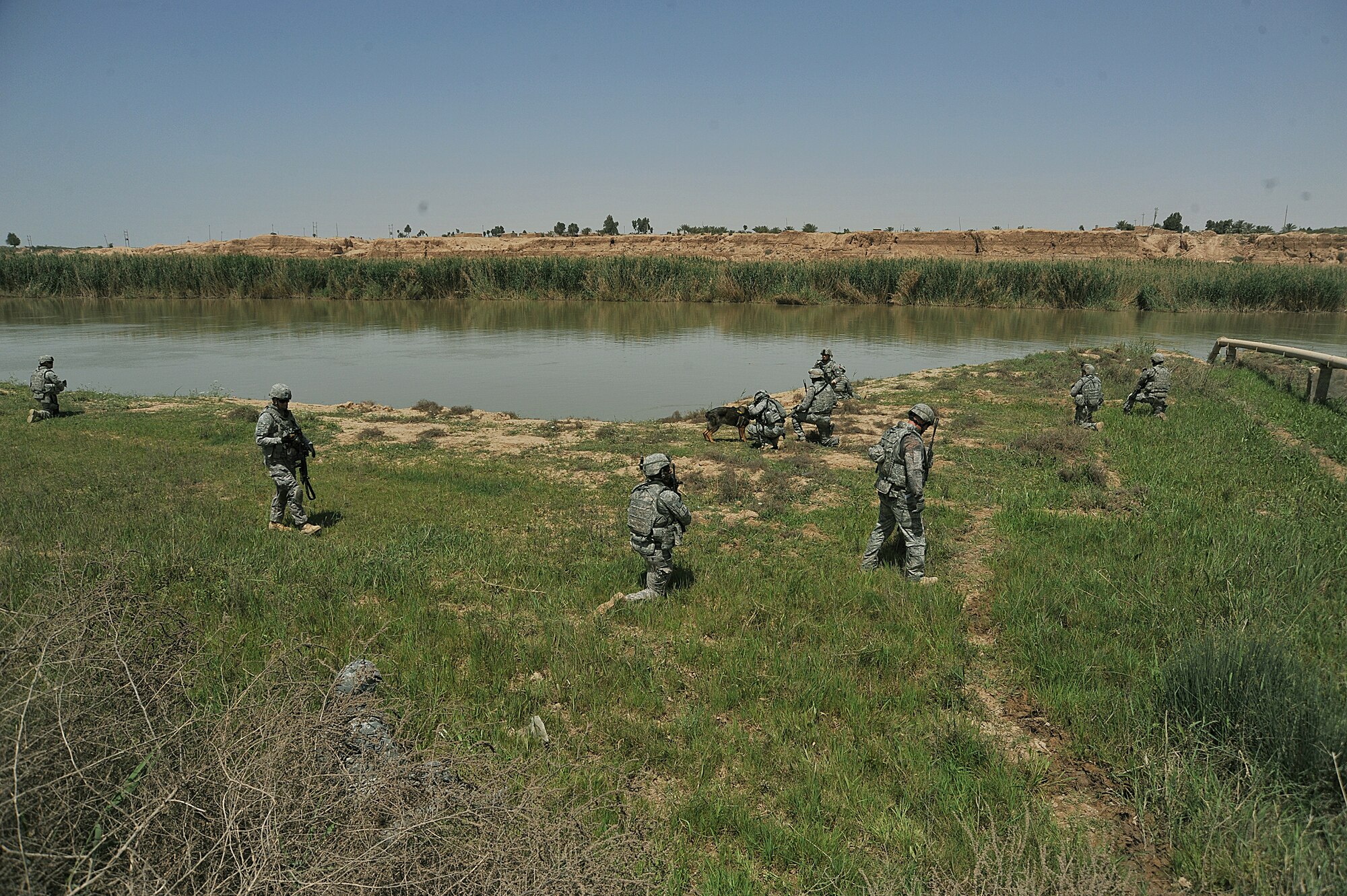 U.S. Air Force and Army personnel take a break along the Tigris river while conducting a dismounted patrol on the outskirts of Joint Base Balad on April 14, 2010.  The patrol was a joint effort between U.S. Army and Air Force members looking for a weapons cache.(U.S. Air Force photo/Staff Sgt Quinton Russ/released)