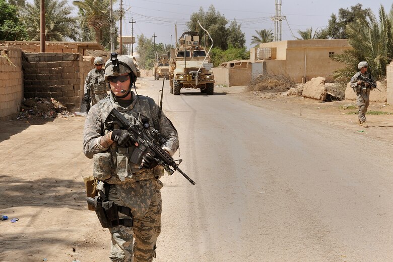 U.S. Air Force Staff Sgt. Benjamin Wilson patrols a village on the outskirts of Joint Base Balad April 14, 2010.  The patrol was a joint effort between U.S. Army and Air Force defenders looking for a weapons cache.  Sgt. Wilson is forward deployed to the 532nd Expeditionary Security Forces Squadron from Vandenberg AFB, Calif.  (U.S. Air Force photo/Staff Sgt Quinton Russ/released)