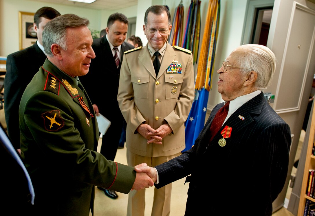 Russian Gen. Nikolay Makarov, left, chief of the General Staff of the Russian Federation, and U.S. Navy Adm. Mike Mullen, chairman of the Joint Chiefs of Staff, congratulate Igor Bleousovitch after presenting him with a Russian Presidential Medal at the Pentagon, April 23, 2010. The medal commemorates the 65th anniversary of his participation at a meeting of U.S. and Russian forces at Elbe River in Germany, April 25, 1945. Bleousovitch, an U.S. Army World War II veteran, documented the meeting.