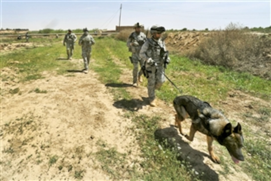 U.S. Air Force airmen patrol near the Tigris River on the outskirts of Joint Base Balad, Iraq, April 14, 2010, to look for a weapons cache.