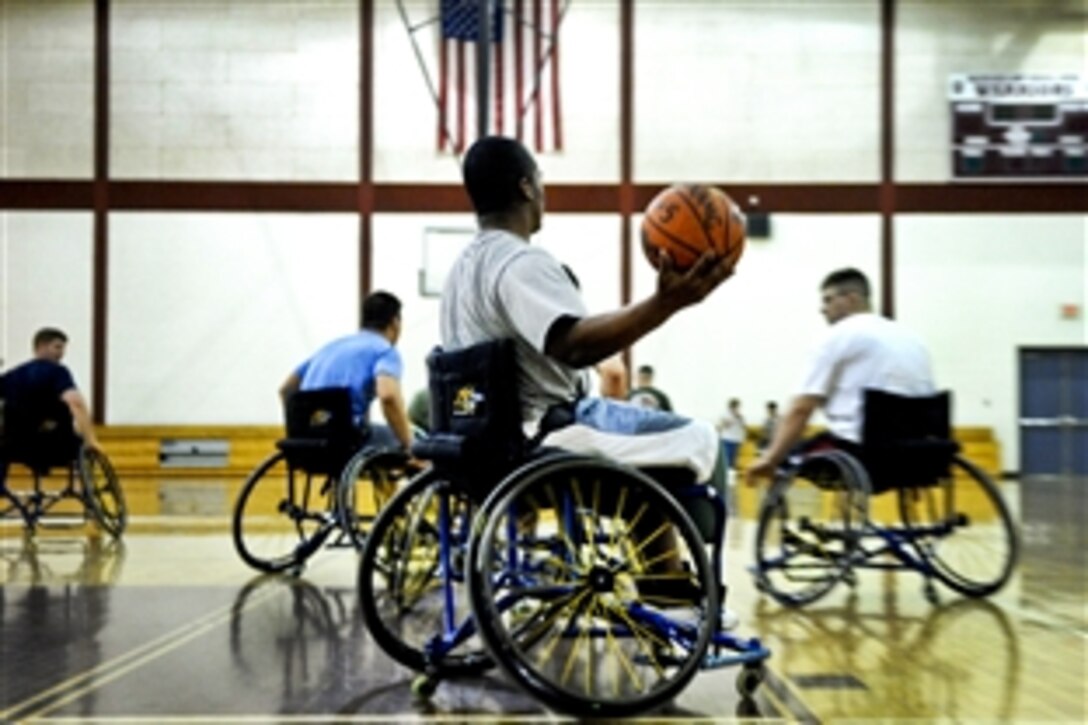 U.S. Army Spc. Craig C. Smith, a below-the-right-knee amputee and Operation Iraqi Freedom veteran recovering at Walter Reed Army Medical Center in Washington, D.C., gets ready to throw an outlet pass down court during a wheelchair basketball practice, April 13, 2010. Smith and others recovering at Walter Reed are training for the inaugural Warrior Games May 10-14 in Colorado Springs, Colo.