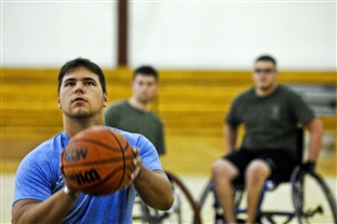 Retired U.S. Marine Corps Lance Cpl. Tim Lang, a below-the-right-knee amputee and Operation Iraqi Freedom veteran recovering at Walter Reed Army Medical Center in Washington, D.C., shoots a basketball during a wheelchair basketball practice, April 13, 2010. Lang and others recovering at Walter Reed are training for the inaugural Warrior Games May 10-14 in Colorado Springs, Colo. 
