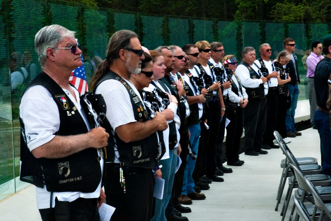 Members of the NC-5 chapter of Rolling Thunder, an organization for Vietnam War veterans, stand during the playing of the national anthem during the Vietnam Recognition Day at the Lejeune Memorial Gardens, April 24. The event is in remembrance of all Vietnam veterans and the mental and physical scars they live with every day.