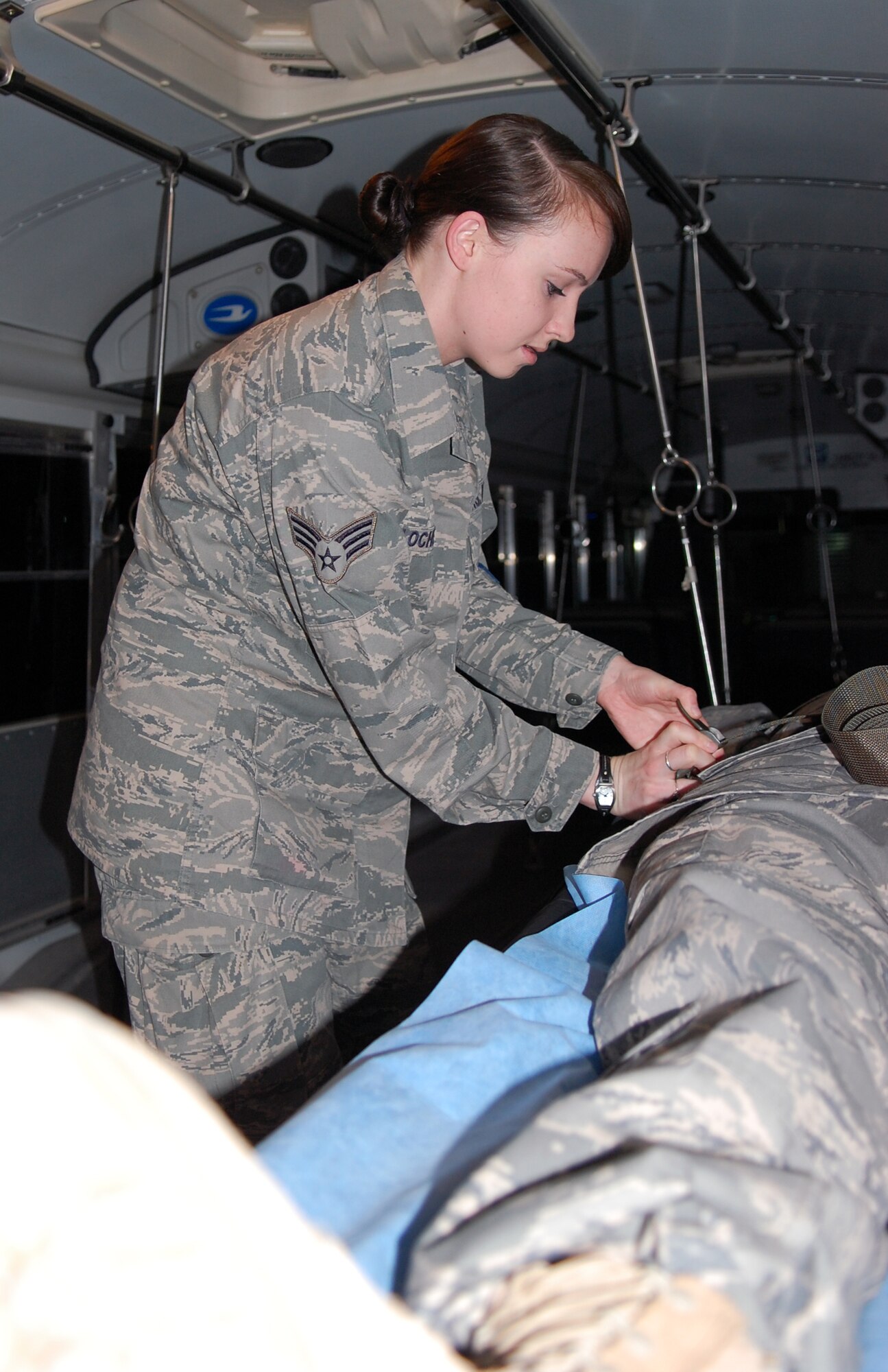 U.S. Air Force Senior Airman Nikayla Locher, 386th Expeditionary Medical Group aerospace medical service technician, practices securing a patient. Airman Locher is deployed from Wright-Patterson Air Force Base, Ohio. (U.S. Air Force photo by Staff Sgt. Lakisha A. Croley/Released)