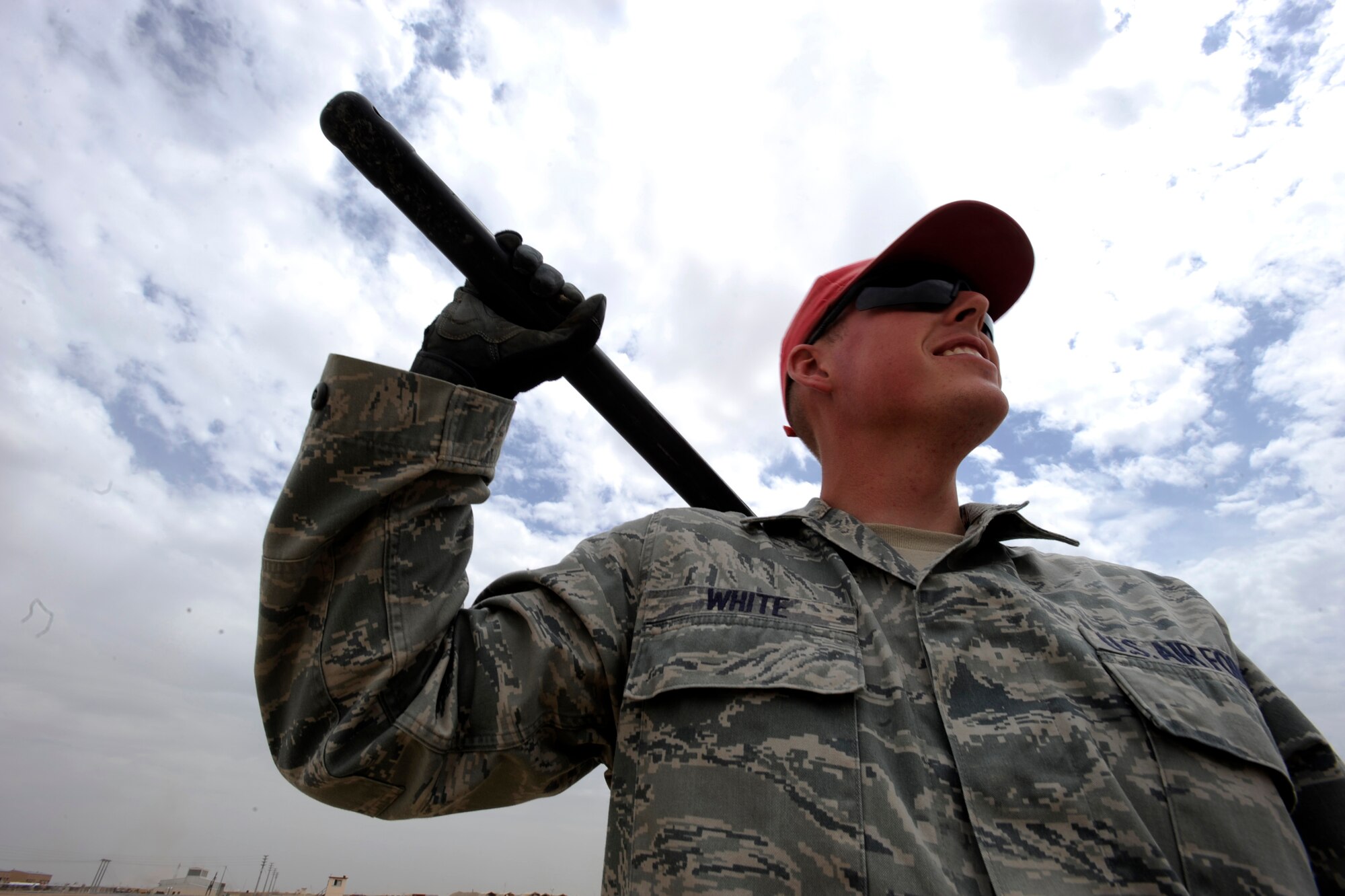 Airman First Class Daniel White, structural craftsman assigned to the 1st Expeditionary RED HORSE Group, takes a break to talk with co-workers at an evaporation pond work site, April 19, 2010, at Camp Leatherneck, Afghanistan. (U.S. Air Force photo/Staff Sgt. Manuel J. Martinez/released)
