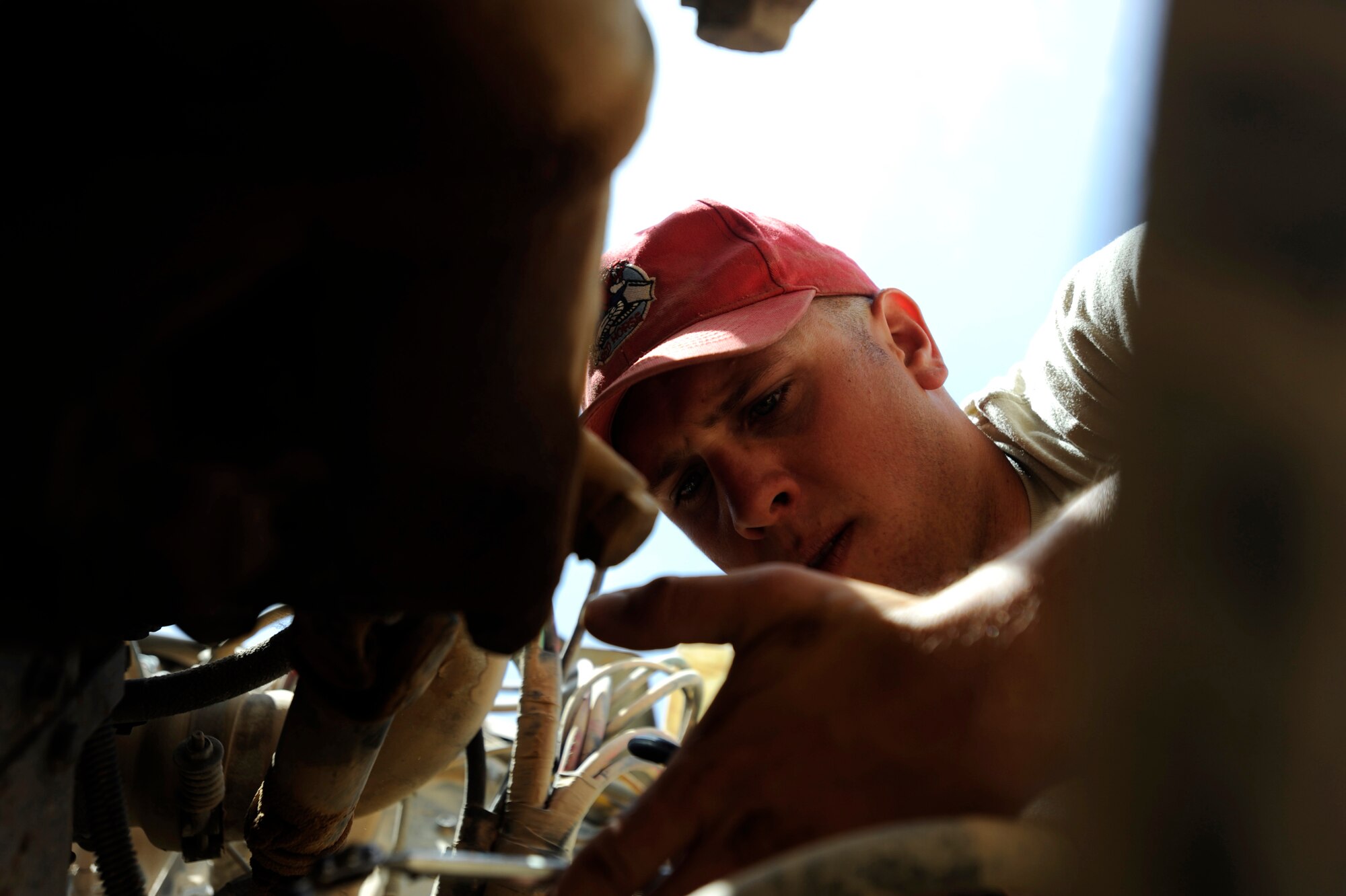 Staff Sgt. Terry Broshious, a vehicle maintainer assigned to the 1st Expeditionary RED HORSE Group, checks on a part number for a dump truck component at a work site, April 19, 2010, at Camp Leatherneck, Afghanistan. "If there's daylight outside we're working," said Staff Sgt. Terry Broshious, 1st ERED HORSE Group vehicle maintainer deployed from the Ohio Air National Guard's 200th RED HORSE Squadron. "We cannot afford to have one vehicle out of order, we have a small team so we have to stay on top of all of our projects and as long as we're working, my team is going keep them running." (U.S. Air Force photo/Staff Sgt. Manuel J. Martinez/released)

