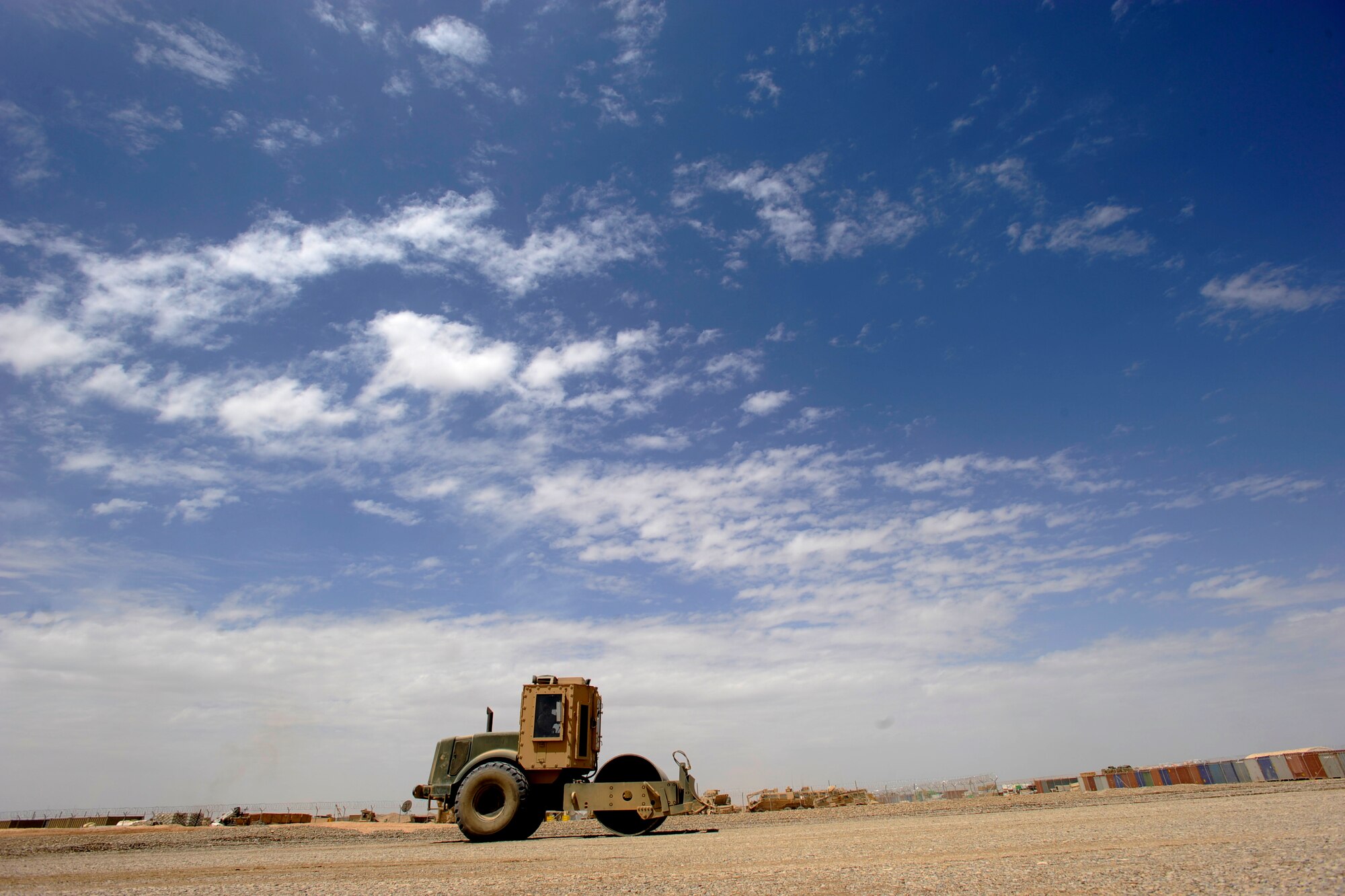 Airman First Class Andrew Lesher, a heavy equipment operator assigned to the 1st Expeditionary RED HORSE Group, utilizes a rolling truck to flatten the ground at the job site of a future Air Force RED HORSE compound, at April 19, 2010, Camp Leatherneck, Afghanistan.  As the team works from sun up to sun down to get projects completed, the 14 pieces of  construction equipment and three trucks the RED HORSE team utilizes have to continue running in peak condition. (U.S. Air Force photo/Staff Sgt. Manuel J. Martinez/released)