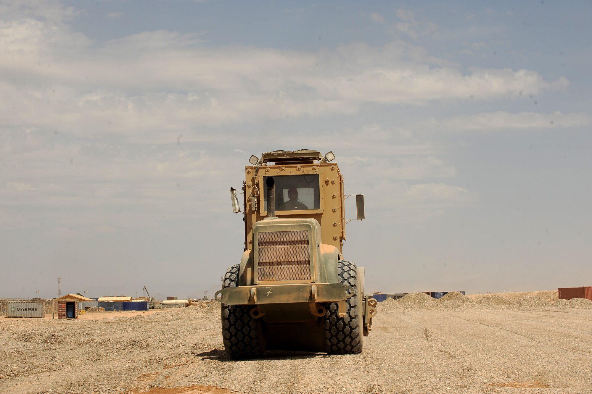 Airman First Class Andrew Lesher, a heavy-equipment operator assigned to the 1st Expeditionary RED HORSE Group, utilizes a rolling truck to flatten ground at the future site of an Air Force RED HORSE compound, April 19, 2010, at Camp Leatherneck, Afghanistan. As 30,000 servicemembers continue to pour into the region as part of the troop surge in Afghanistan, a 15-man team of Airmen with the 1st Expeditionary RED HORSE Group are paving the way to ensure the warfighters here have the facilities they need. (U.S. Air Force photo/Staff Sgt. Manuel J. Martinez/released)