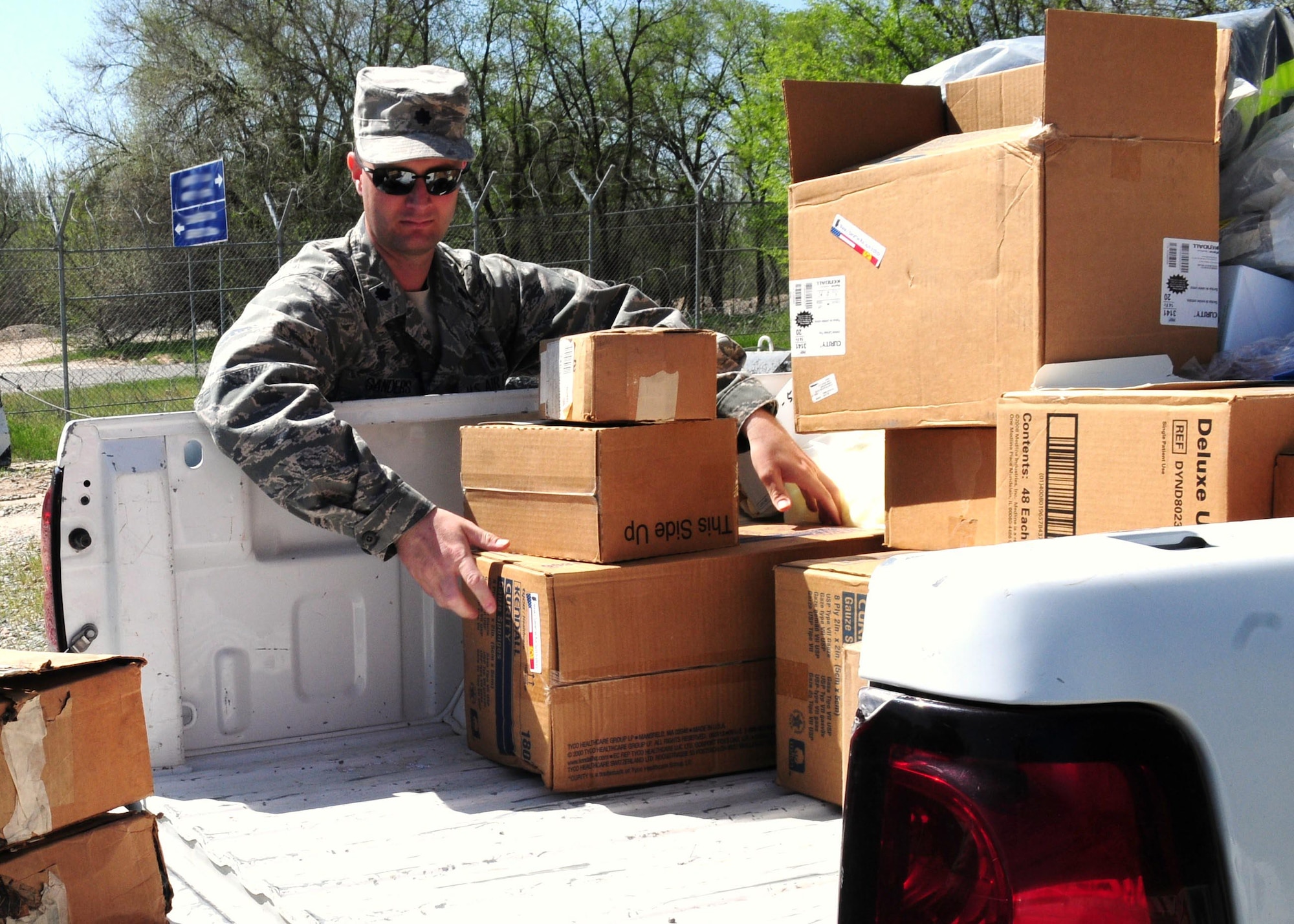 Lt. Col. Tyler Sanders, 376th Expeditionary Medical Group chief administrator, unloads medical supplies donated by the Transit Center at Manas to three local hospitals in Bishkek, Kyrgyzstan, April 23, 2010.  The EMDG donated approximately $83,000 of medical supplies between the three hospitals. (U.S. Air Force photo/Senior Master Sgt. Mike Litsey/released) 