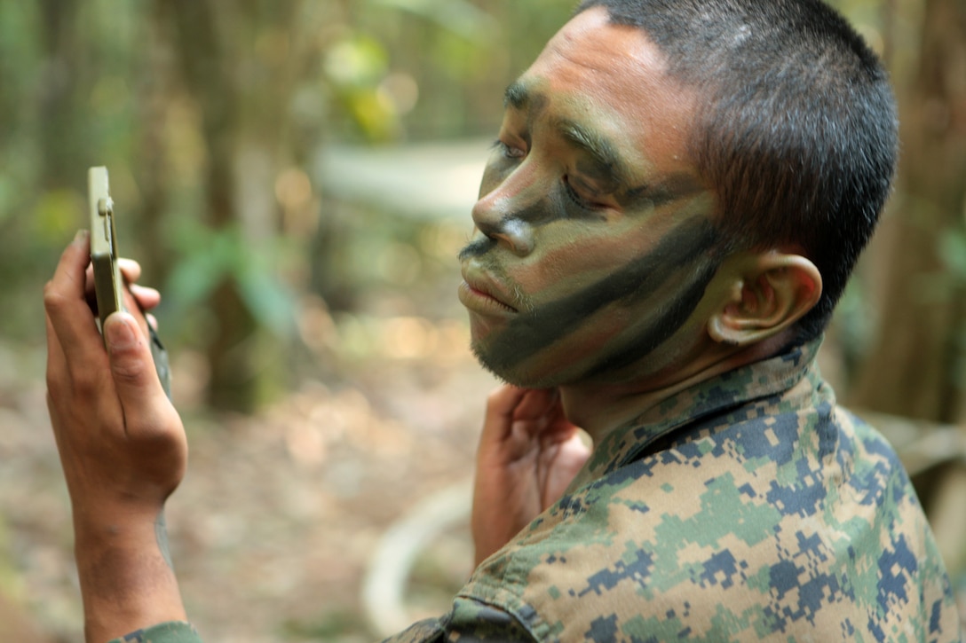 – Marine Lance Cpl. Charles Gregorio, mortarman, 2nd Batallion, 23rd Marine Regiment, Company F, applies camoflauge paint to his face shortly before kicking off close target reconissance training as part of the Belize Defense Force jungle warfare during Tradewinds 2010, a U.S. Southern Command sponsored annual exercise that is conducted with Caribbean Basin partner nations, designed to improve cooperation with the partner nations in responding to regional security threats.