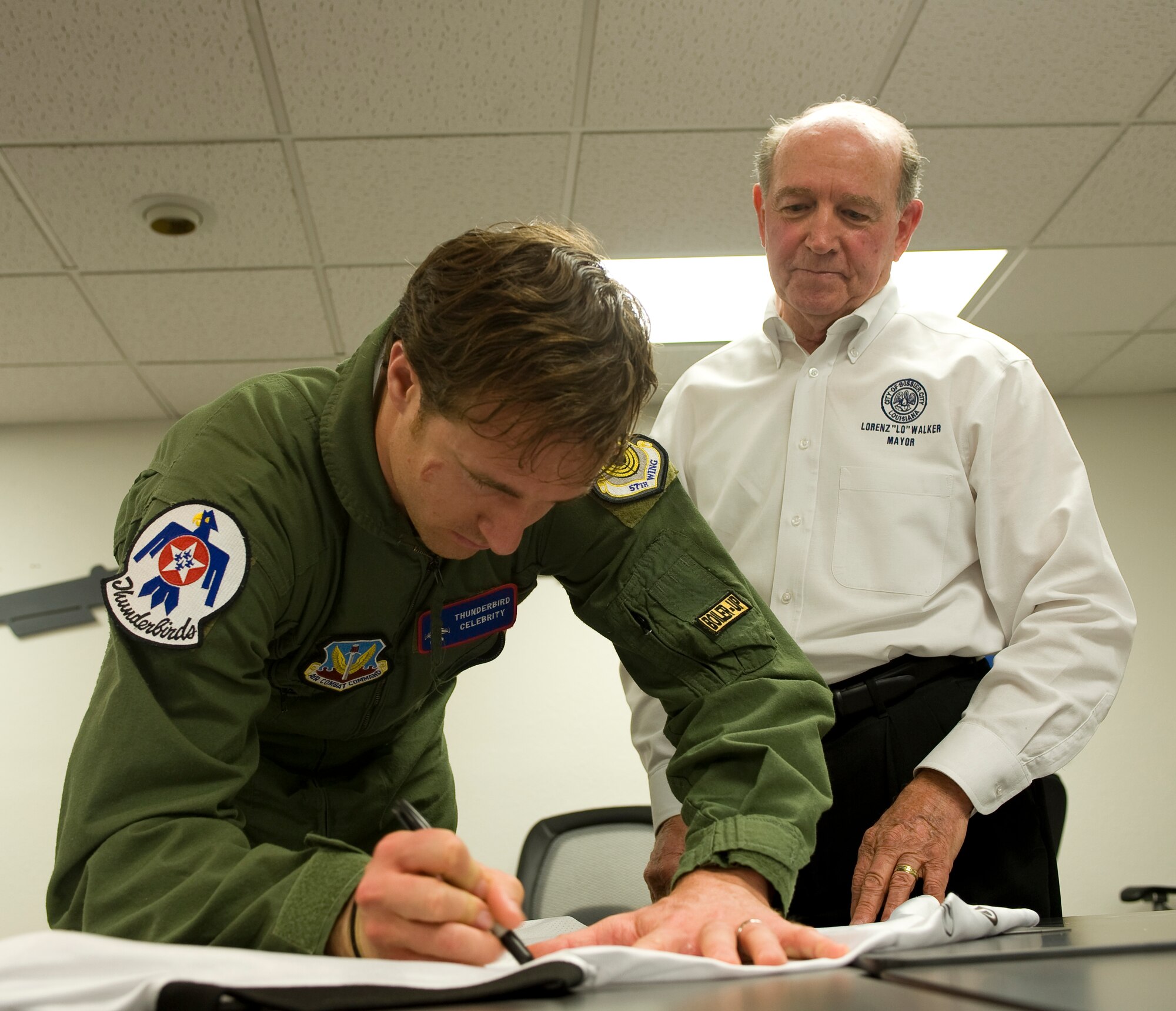 BARKSDALE AIR FORCE BASE, La. -- Drew Brees, New Orleans Saints quarterback and Super Bowl XLIV MVP, autographs a jersey for Bossier City Mayor Lorenz Walker here Friday, April 23. Drew Brees and teammate Jabari Greer visited Barksdale to meet with Airmen and fly with the Thunderbirds. (U.S. Air Force photo by Senior Airman Chad Warren)(RELEASED)
