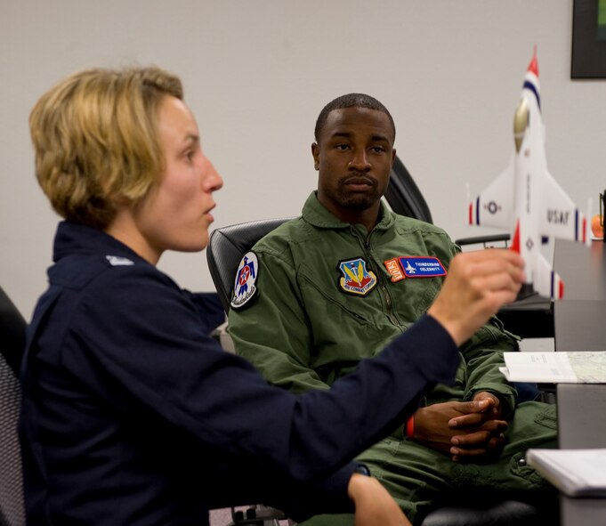 BARKSDALE AIR FORCE BASE, La. -- Capt. Kristin Hubbard, United States Air Force Thunderbirds narrator, explains the flight plan to New Orleans Saints defensive back Jabari Greer before his flight in an F-16 here Friday, April 23. Captain Hubbard used a model F-16 to demonstrate the maneuvers that they will perform during the flight. (U.S. Air Force photo by Senior Airman Chad Warren)(RELEASED)