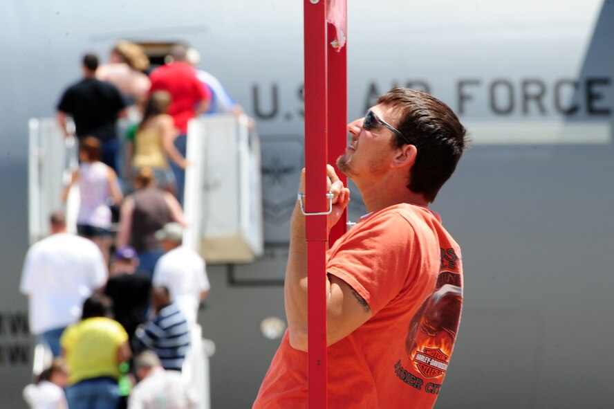 BARKSDALE AIR FORCE BASE, La. -- Shreveport native Christopher Falls does chin-ups at the Marine Corps recruiting booth during the 2010 Defenders of Liberty Air Show April 25. Recruiters from all four branches of the military were on-hand during the show to entertain air show guests with their interactive displays. (U.S. Air Force photo by Senior Airman Joanna M. Kresge)