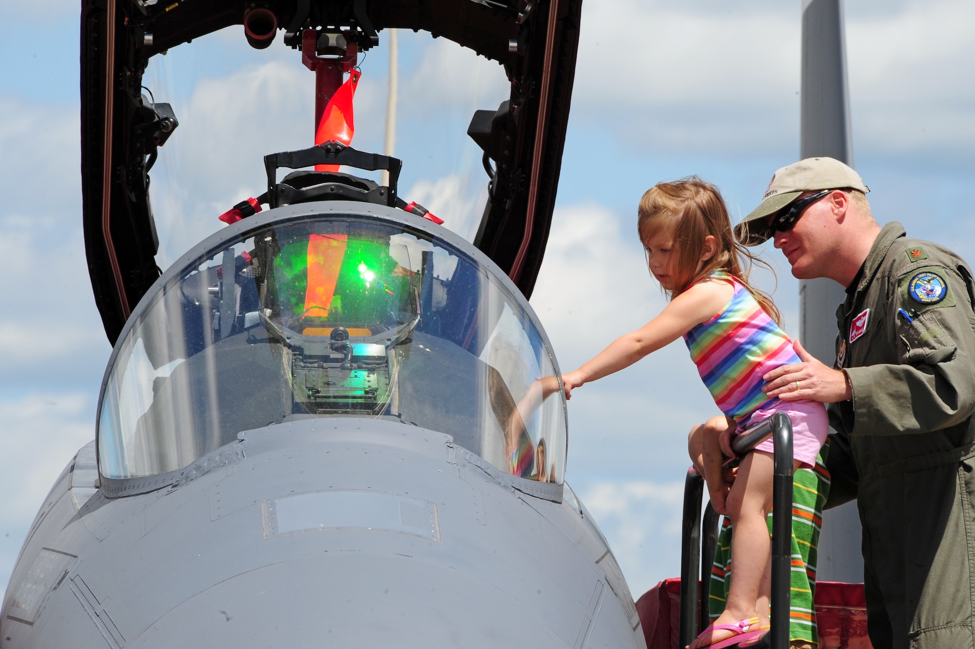 BARKSDALE AIR FORCE BASE, La. -- Eglin Air Force Base's Maj. Darren Wees, 40th Flight Test Squadron, shows Hannah Higgins, 6, the interior of an F-15E Strike Eagle during the Defenders of Liberty Air Show April 25. Like many other families who traveled to attend the air show, some from as far as Mexico, the Higgins family traveled from Texas to visit Barksdale. (U.S. Air Force photo by Senior Airman Joanna M. Kresge)