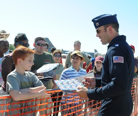 BARKSDALE AIR FORCE BASE, La. – Capt. Aaron Jelinek, Thunderbird 6 opposing solo, signs an autograph for a spectator after their performance. The Thunderbirds performed  April 24 and 25 during the Barksdale 2010 Defenders of Liberty Air Show. (U.S. Air Force photo by Senior Airman Alexandra M. Longfellow) (RELEASED)