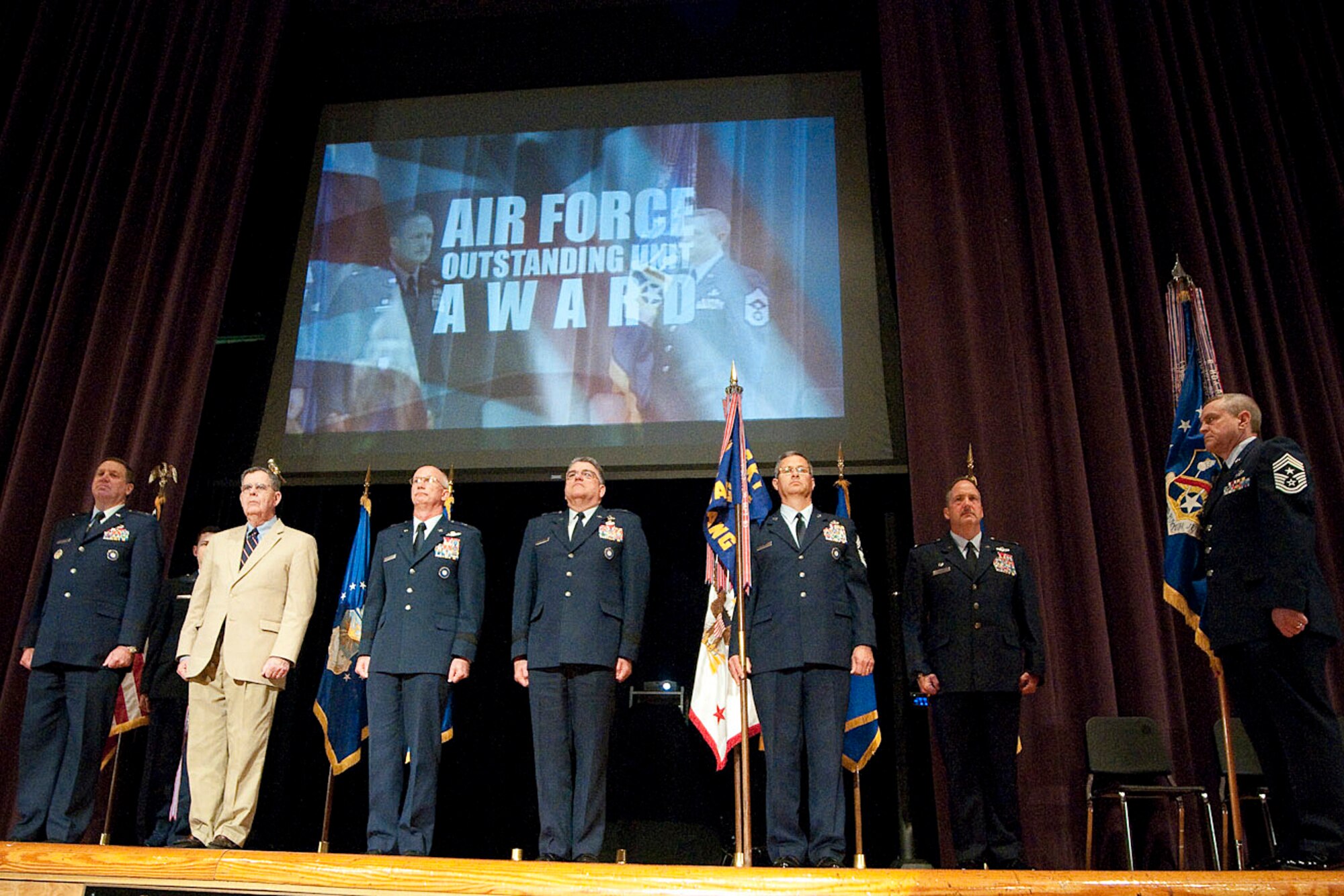 Kentucky National Guard officials prepare to accept the 123rd Airlift Wing's 14th Air Force Outstanding Unit Award from Dennis M. McCarthy, assistant secretary for Reserve Affairs (second from left) during a ceremony held April 17, 2010 at Louisville Male High School in Louisville, Ky. Pictured from left to right are Kentucky's adjutant general, Maj. Gen. Edward W. Tonini; Secretary McCarthy; Brig. Gen. Mark Kraus, Kentucky's assistant adjutant general for Air; Brig. Gen. Michael Dornbush, chief of staff, headquarters, Kentucky Air National Guard; Chief Master Sgt. James Smith, state command chief master sergeant for the Kentucky Air National Guard; Col. Gregory Nelson, commander of the 123rd Airlift Wing; and Chief Master Sgt. Curtis Carpenter, command chief master sergeant of the 123rd Airlift Wing. (U.S. Air Force photo/Senior Airman Maxwell Rechel)