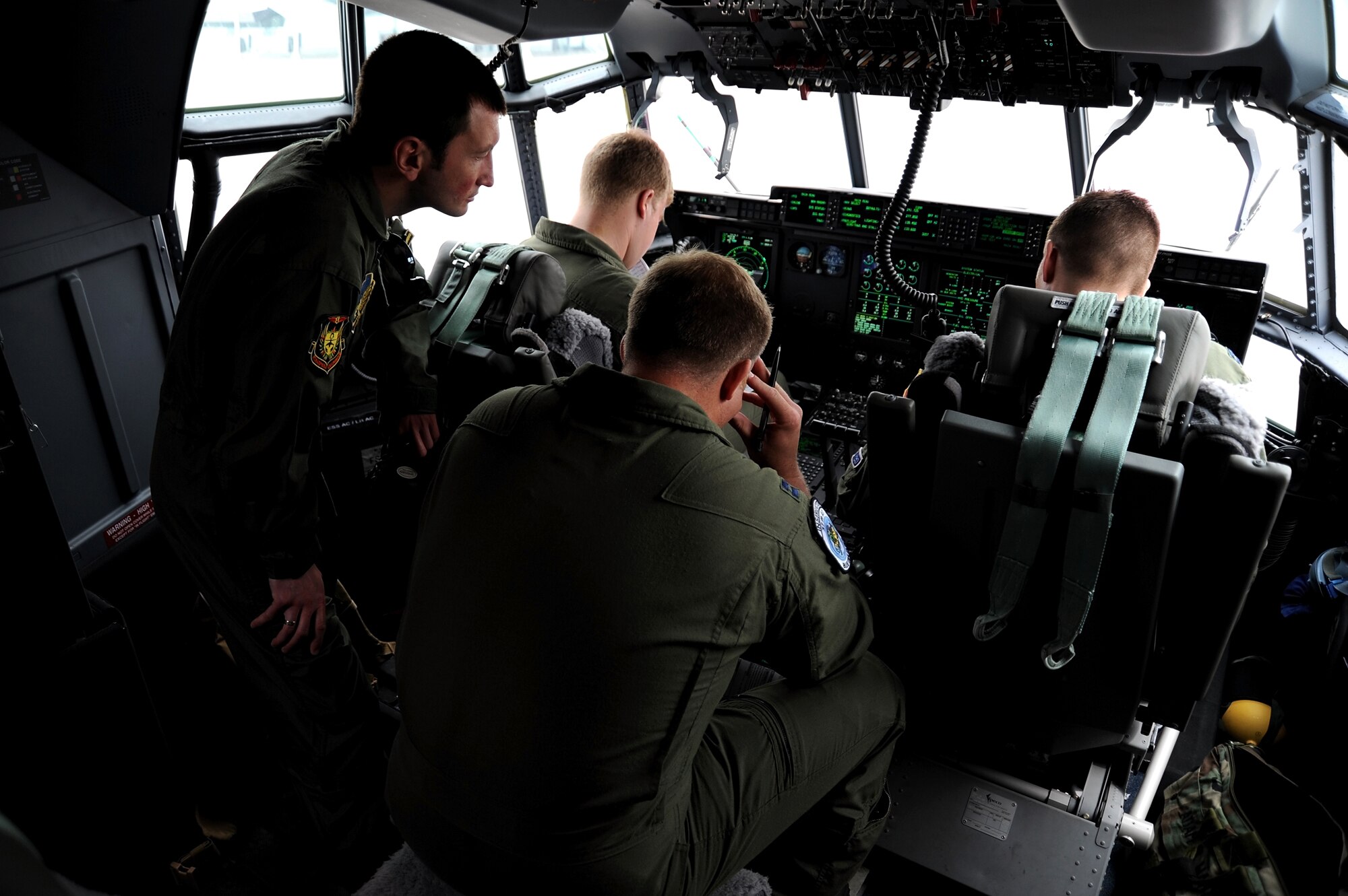 Bulgarian Lt. Hristo Valev, a Mi-24 pilot from the 24th Bulgarian Air Force, looks over the shoulders of U.S. Air Force Capt. Jeff Davis, 1st Lt. Scott Lichtwardt and Capt. Adam Wantuck, all from the 37th Airlift Squadron, as they complete startup checks on a C-130 J during exercise Thracian Spring 10 at Plovdiv Airport on April 24, 2010. Personnel from the 86th Airlift Wing and 435th Air and Ground Operations Wing are deployed to Plovdiv, Bulgaria, in support of Thracian Spring. Thracian Spring is an exercise composed of aircrew, maintenance, airfield management, aerial port, security forces, and logistics personnel that combine their skill in an effort to build and strengthen the United States and Bulgarian Air Forces bond while improving interoperability with our partner NATO nation. (U.S. Air Force photo by Master Sgt. Quinton T. Burris)