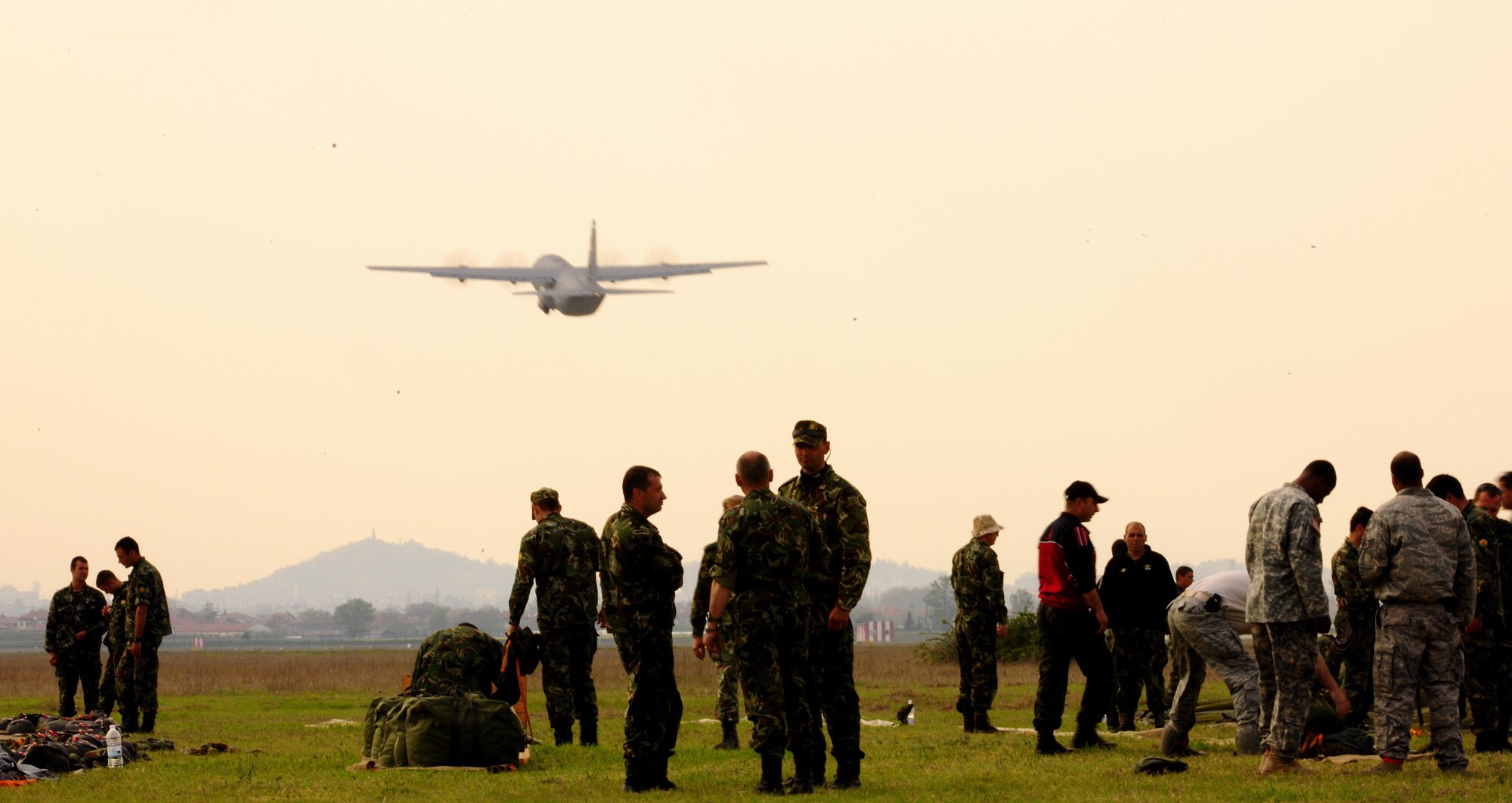 Members of the Bulgarian 68th Special Forces Brigade pack their parachutes after jumping from a U.S. Air Force C-130 J during exercise Thracian Spring 2010 at Plovdiv Airport, April 23, 2010. Personnel from the 86th Airlift Wing and 435th Air and Ground Operations Wing are deployed to Plovdiv, Bulgaria in support of Thracian Spring. Thracian Spring is an exercise composed of aircrew, maintenance, airfield management, aerial port, security forces, and logistics personnel that combine their skill in an effort to build and strengthen the United States and Bulgarian Air Forces’ bond while improving interoperability with our partner NATO nation. (U.S. Air Force photo by Master Sgt. Quinton T. Burris)