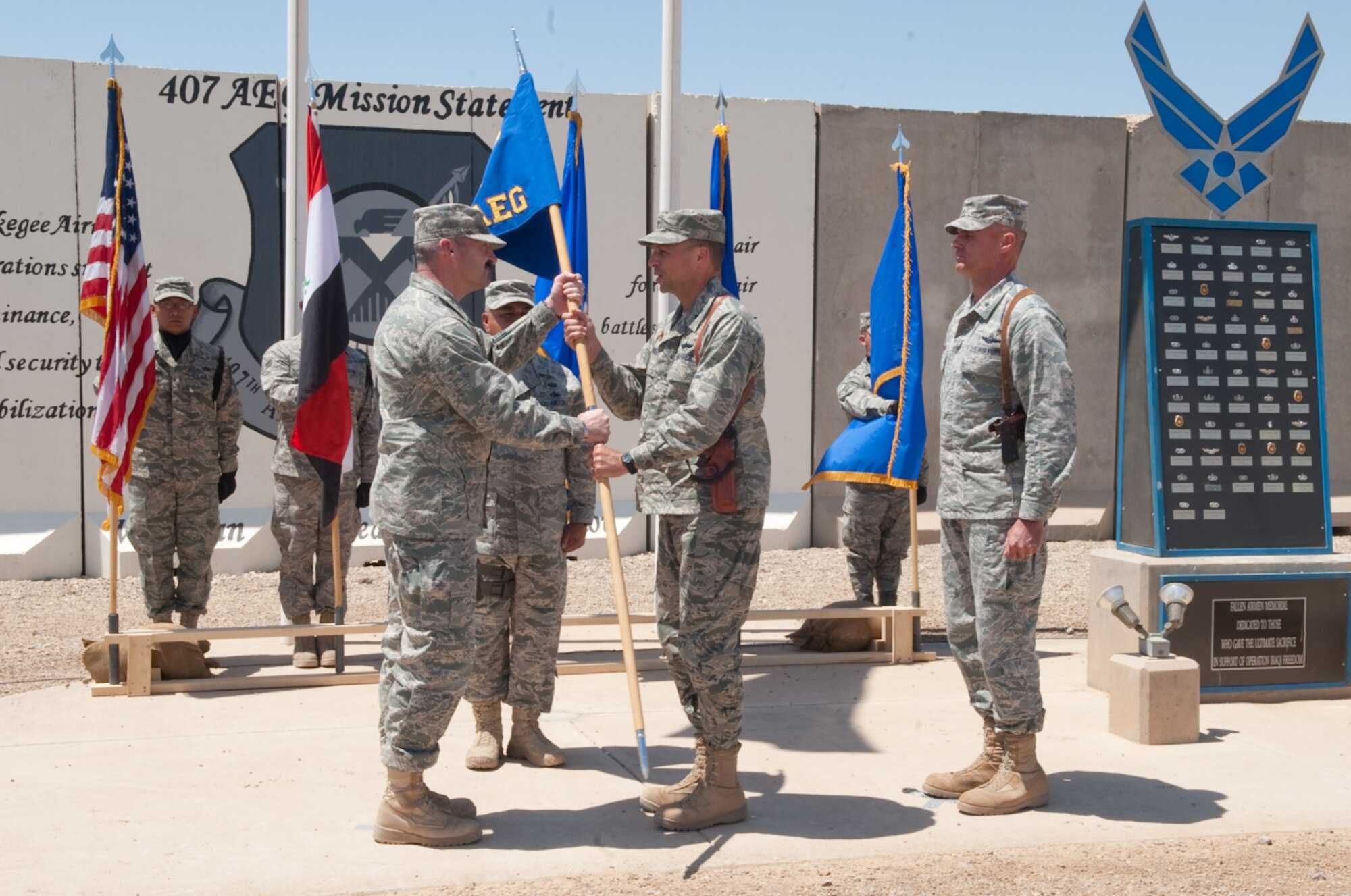 Maj. Gen. Joseph Reynes Jr., director, Air Component Coordination Element U.S. Forces-Iraq hands the guidon to Brig. Gen. Scott M. Hanson, commander, 321st Air Expeditionary Wing from Brig. Gen Craig A. Frianklin, commander, 332nd Air Expeditionary Group signifying the new authority over the 407th Air Expeditionary Group during the transfer of authority at Ali Base, Iraq, April 24, 2010. The mission of the 321 AEW is to train and advise the Iraqi Air Force. (U.S. Air Force photo by Senior Master Sgt. Elizabeth Gilbert/Released)
