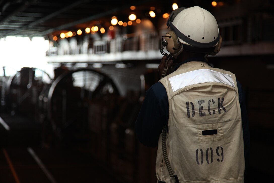 A sailor oversees the preparation of Landing Craft Air Cushioned as they prepare to leave the well deck of USS Kearsarge off the shore of Camp Lejeune, N.C., April 26, 2010. 26th Marine Expeditionary Unit is embarked aboard USS Kearsarge, USS Carter Hall, and USS New York for Amphibious Squadron (PHIBRON)/ Marine Expeditionary Unit Integration (PMINT) training. PMINT integrates 26th MEU Marines with their Navy counterparts to train in planning and execution of missions they could conduct when they deploy together this fall.::r::::n::::r::::n::