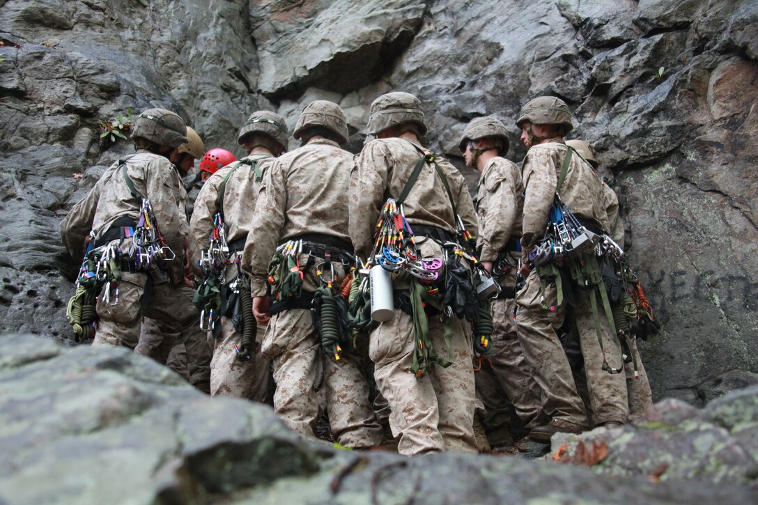 Marines with 26th Marine Expeditionary Unit gather at the base of cliff during a class at the Assault Climbers Course at Lower Cliff in Kingwood, W.Va., April 26, 2010. The class learned different techniques for moving themselves and others quickly over man-made and natural occurring objects. The Assault Climbers Course is one of several Special Operations Training Group, II Marine Expeditionary Force events as part of 26th MEU's preparation for deployment this fall. (Official USMC photo by Staff Sgt. Danielle M. Bacon) ::r::::n::