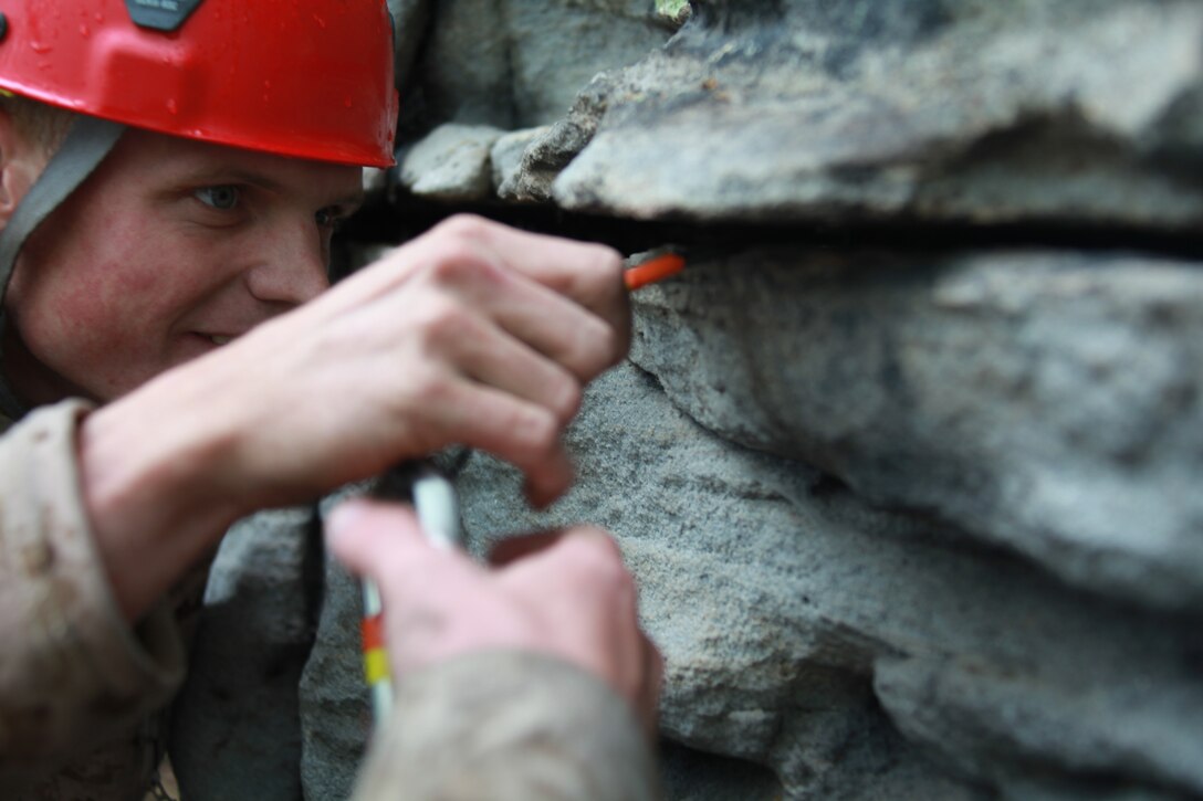Sgt. Thomas Barrows, an Assault Climbers Course instructor with Special Operations Training Group, II Marine Expeditionary Force checks gear placement during a class at the Assault Climbers Course at Lower Cliff in Kingwood, W.Va., April 26, 2010. The class learned different techniques for moving themselves and others quickly over man-made and natural occurring objects. The Assault Climbers Course is one of several Special Operations Training Group events as part of 26th MEU's preparation for deployment this fall. (Official USMC photo by Staff Sgt. Danielle M. Bacon) ::r::::n::