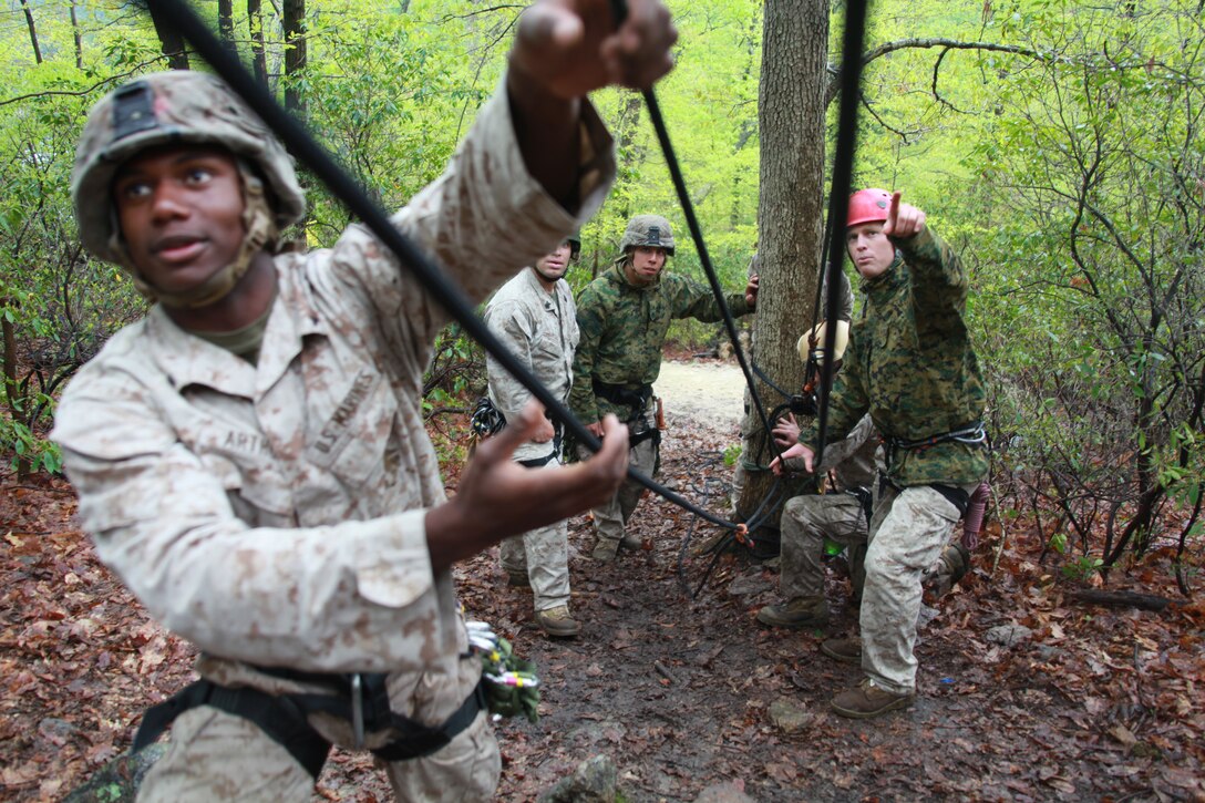 Assault Climbers Course instructor with Special Operations Training Group, Capt. Robert Long gives instructions to Lance Cpl. Anthony Arthur, an team leader with Company I, Battalion Landing Team 3/8, 26th Marine Expeditionary Unit as he helps to tie off a 300-foot static line during training at Lower Cliff in Kingwood, W.Va., April 26, 2010. The class of Marines from the 26th Marine Expeditionary Unit learn different techniques for moving  themselves and others quickly over man-made and natural occurring objects. The Assault Climbers Course is one of several Special Operations Training Group, II Marine Expeditionary Force events as part of 26th MEU's preparation for deployment this fall. (Official USMC photo by Staff Sgt. Danielle M. Bacon) ::r::::n::