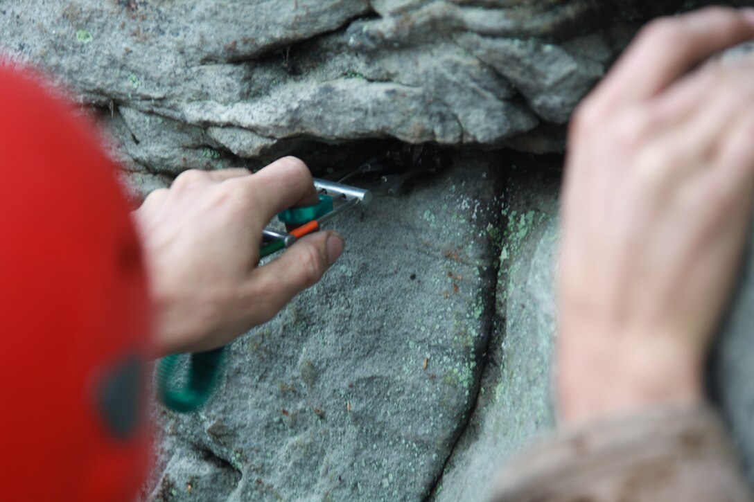 Sgt. Thomas Barrows, an Assault Climbers Course instructor with Special Operations Training Group, II Marine Expeditionary Force demonstrates proper gear placement during a class at the Assault Climbers Course at Lower Cliff in Kingwood, W.Va., April 26, 2010. The gear is called friends, because it will help save lives in case of falls from a mountain. The class learned different techniques for moving themselves and others quickly over man-made and natural occurring objects. The Assault Climbers Course is one of several Special Operations Training Group events as part of 26th MEU's preparation for deployment this fall. (Official USMC photo by Staff Sgt. Danielle M. Bacon) ::r::::n::