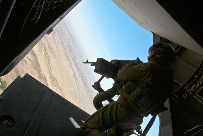 Staff Sgt. John Godwin, a Loxley, Ala., native serving as a flight equipment technician and aerial observer with Marine Medium Tiltrotor Squadron 261, 3rd Marine Aircraft Wing (Forward), mans an M240G machine gun on the tail of an MV-22 Osprey while flying missions in Afghanistan.