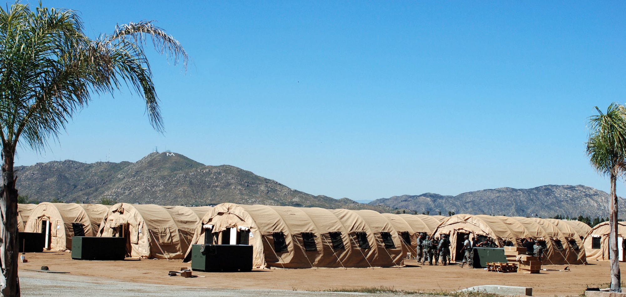 A group of Airmen from the 163rd and 452nd Civil Engineering Squadrons put the finishing touches on the tent city they built at March ARB, April 8. It was the first ever Air National Guard/Air Force Reserve bivouac at March. (U.S. Air Force photo by Megan Just)