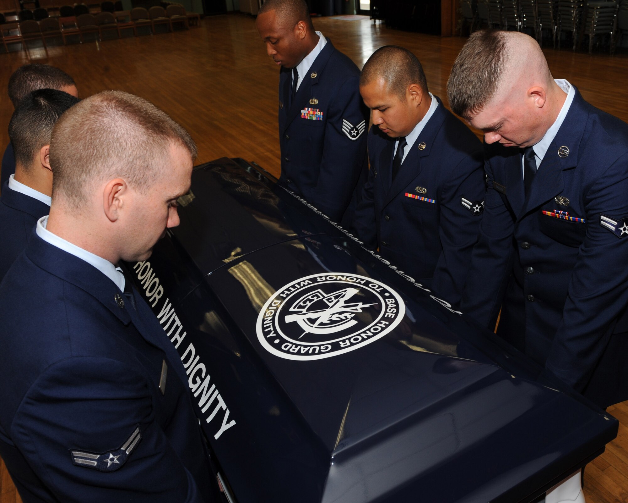 Graduates of the Little Rock Air Force Base honor guard perform the duty of pallbearer April 26, demonstrating the dignity given to military members during funeral ceremonies. The base honor guard's mission is to provide military honors for deserving veterans, retirees, active duty, Guard and Reserve members on base, in Arkansas and the surrounding area on behalf of the president of the United States, the Department of the Air Force and a grateful nation. (U.S. Air Force photo by Staff Sgt. Chad Chisholm)