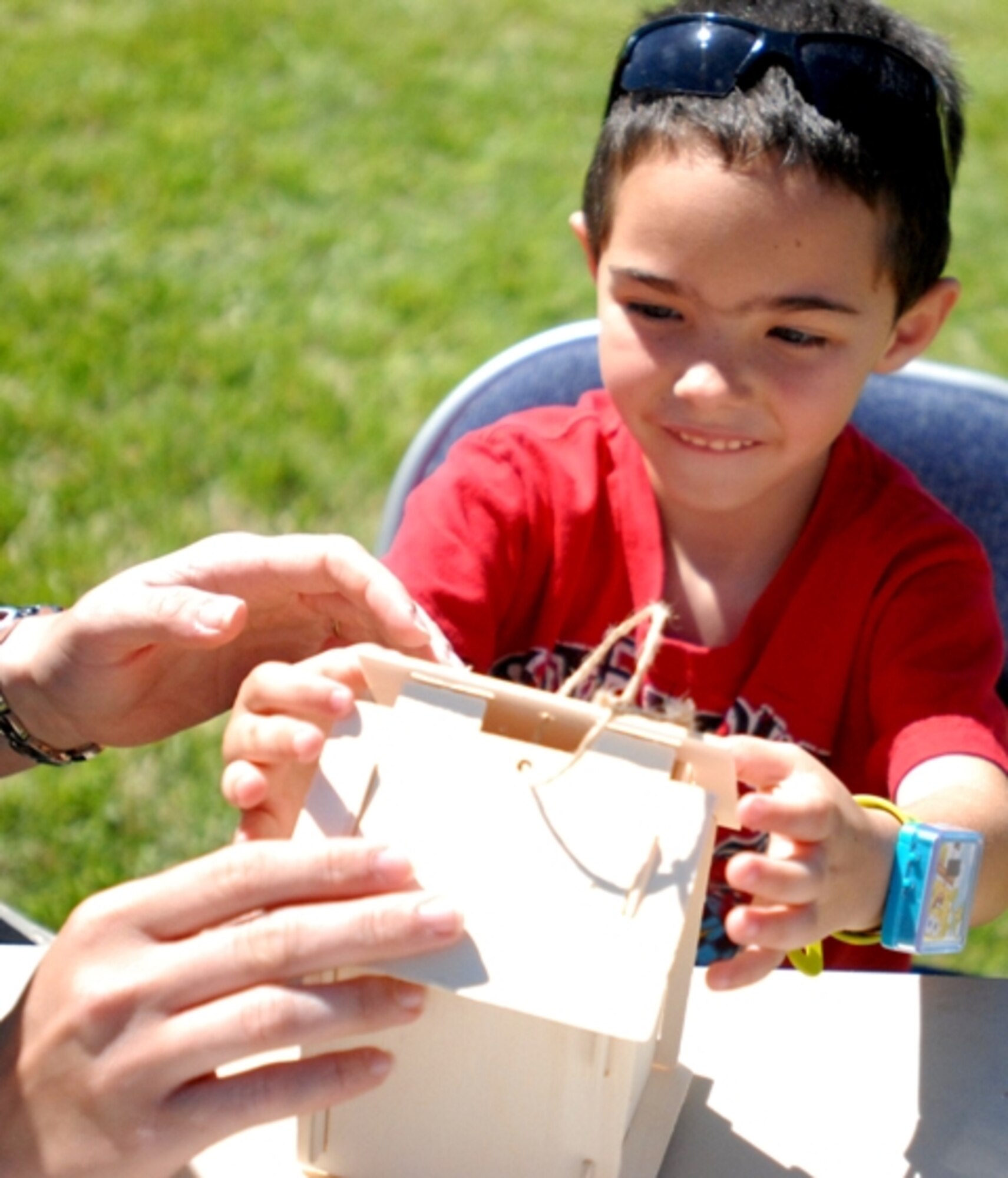 Jonas Bauer, 5, puts together a bird house April 24 in hopes of providing a new home. More than 150 bird houses were made during the 28th Annual Children’s Festival. (U.S. Air Force photo/Connie Hempel)
