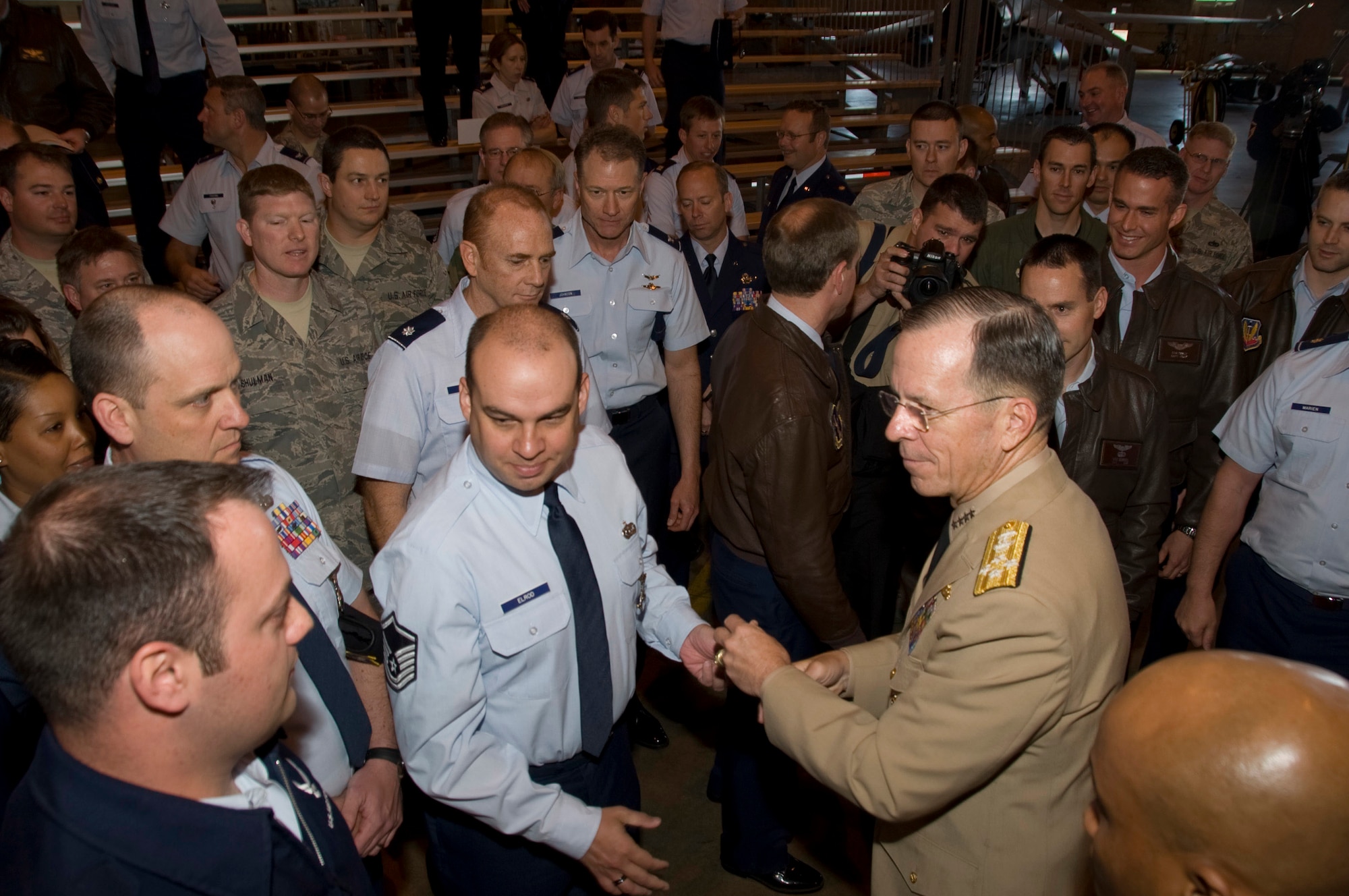 Admiral Mike Mullen, Chairman of the Joint Chiefs of Staff conducted a Town Hall meeting with members of the 140th Wing, Colorado Air National Guard Monday, 26 April 2010.  During the meeting, members of the Air National Guard posed questions concerning the future of the Guard.  Picture here, Admiral meets members of the 140th Wing and presents MSgt Gregory Elrod, 140th Security Forces Squadron, and others with a coin as a token of his appreciation for their service.  (U.S. Air Force Photo/SMSgt John Rohrer) ( RELEASED)