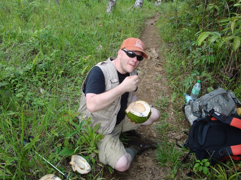 TACLOBAN, Philippines -- Senior Master Sgt. Thomas Niznik, 23rd Maintenance Operations Squadron superintendent, enjoys a fresh coconut here in early April during a 10-day trek on his way to the site where a C-47 Skytrain went down during World War II, leaving its six crew members as “missing in action.” The team was lead by local guides who were ultimately partially responsible for the team’s success in finding the site. (Photo courtesy of Robert Atwater/RELEASED)