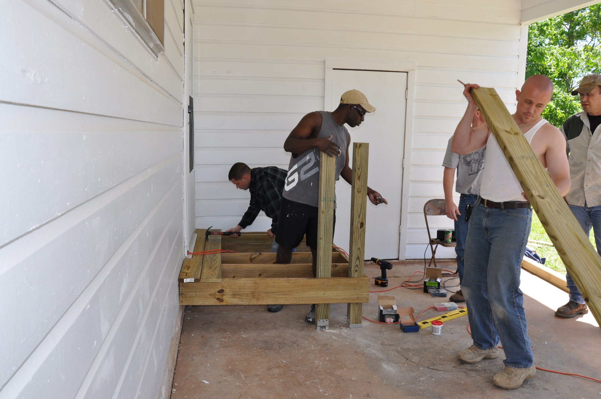 Members of the 366th Training Squadron create a wheelchair ramp for a Wichita Falls, Texas, home during Christmas in Action April 24, 2010. Christmas in Action is a program that has renovated the homes of low-income elderly and disabled homeowners in Wichita County for 27 years. (U.S. Air Force photo/Airman 1st Class Valerie Hosea)