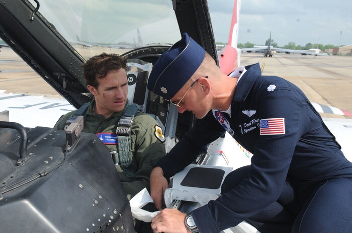 BARKSDALE AIR FORCE BASE, La.--Lt. Col. Derek Routt, operations officer for the U.S. Air Force Air Demonstration Squadron "Thunderbirds," describes the features of the F-16D to New Orleans Saints Quarterback Drew Brees prior to an orientation flight April 23. Selected as the most valuable player during the 2010 Super Bowl, Mr. Brees and the team's Cornerback, Jabari Greer, had the opportunity to meet with Airmen and their families and fly with the Thunderbirds while the squadron was visting Barksdale Air Force Base to perform in the Defenders of Liberty Air Show April 24-25.  Currently in their 57th show season, the Thunderbirds are scheduled to perform 73 shows across the United States and Canada in 2010. (U.S. Air Force photo by Staff Sgt. Richard Rose)