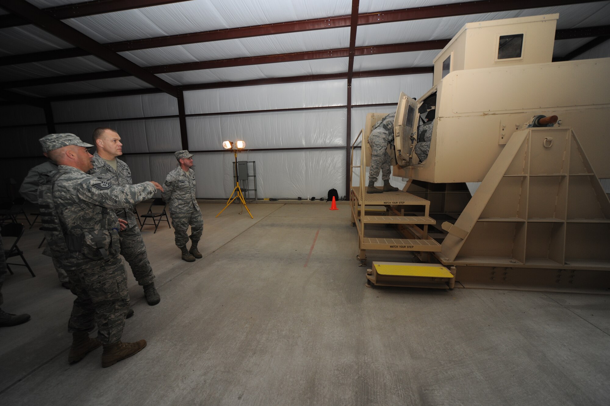 Tech. Sgt. William Lonergan of the 421st Combat Training Squadron’s Contingency Response flight,  explains the capabilities of the HMMWV Egress Assistance Trainer   to Chief Master Sergeant of the Air Force James Roy during a visit to the U.S. Air Force Expeditionary Center at Joint Base McGuire-Dix-Lakehurst April 26.(U.S. Air Force photo by Staff Sgt. Nathaniel Bevier)
