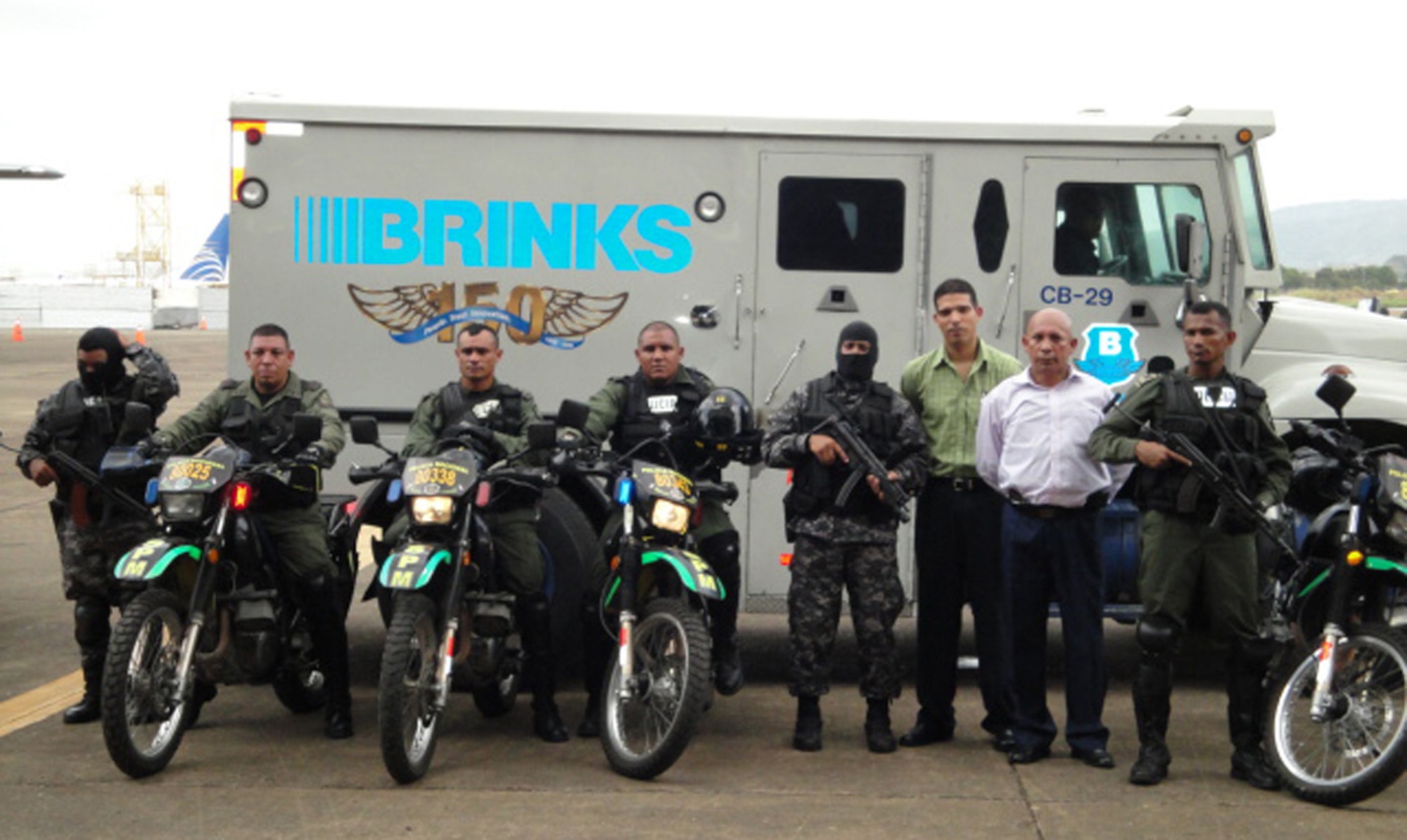 Members of Panama's drug enforcement community pose in front of an armored truck full of seized gold, silver and jewels April 8 at a Panamanian air base. The seized assets, which filled several additional armored trucks, were part of a joint Panama-U.S. investigation into an international drug money laundering scheme in the Central American country. The Air Force Reserve's 302nd Airlift Wing was tasked with flying the seized precious metals and jewels back to the United States for further processing by Department of Justice agencies. (Courtesy photo/Drug Enforcement Agency)
