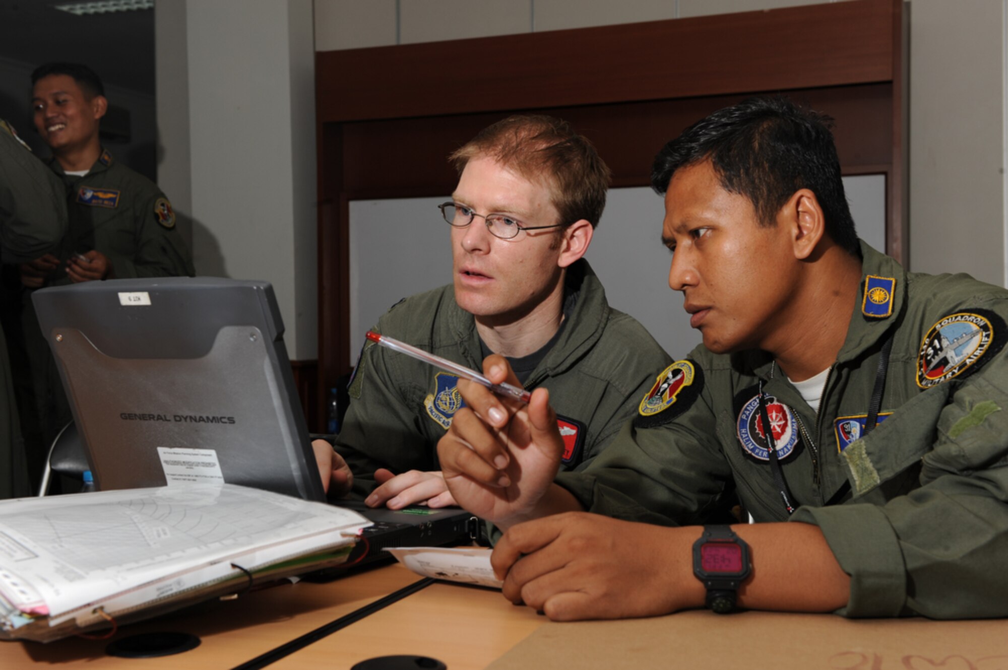 374th Airlift Wing pilot, Capt. Adam Shockley, reviews flight patterns and weather assessments with an Indonesian pilot during Cope West 10 on April 23 at Halim Air Base, Indonesia. Cope West is a Pacific Air Forces sponsored bilateral tactical airlift exercise involving the U.S. and Indonesian air forces. The exercise is designed to advance interoperability between the U.S. and Indonesian air forces, and promote cooperation and unity of purpose.  (U.S.  Air Force photo/Tech Sgt. Cohen A. Young)