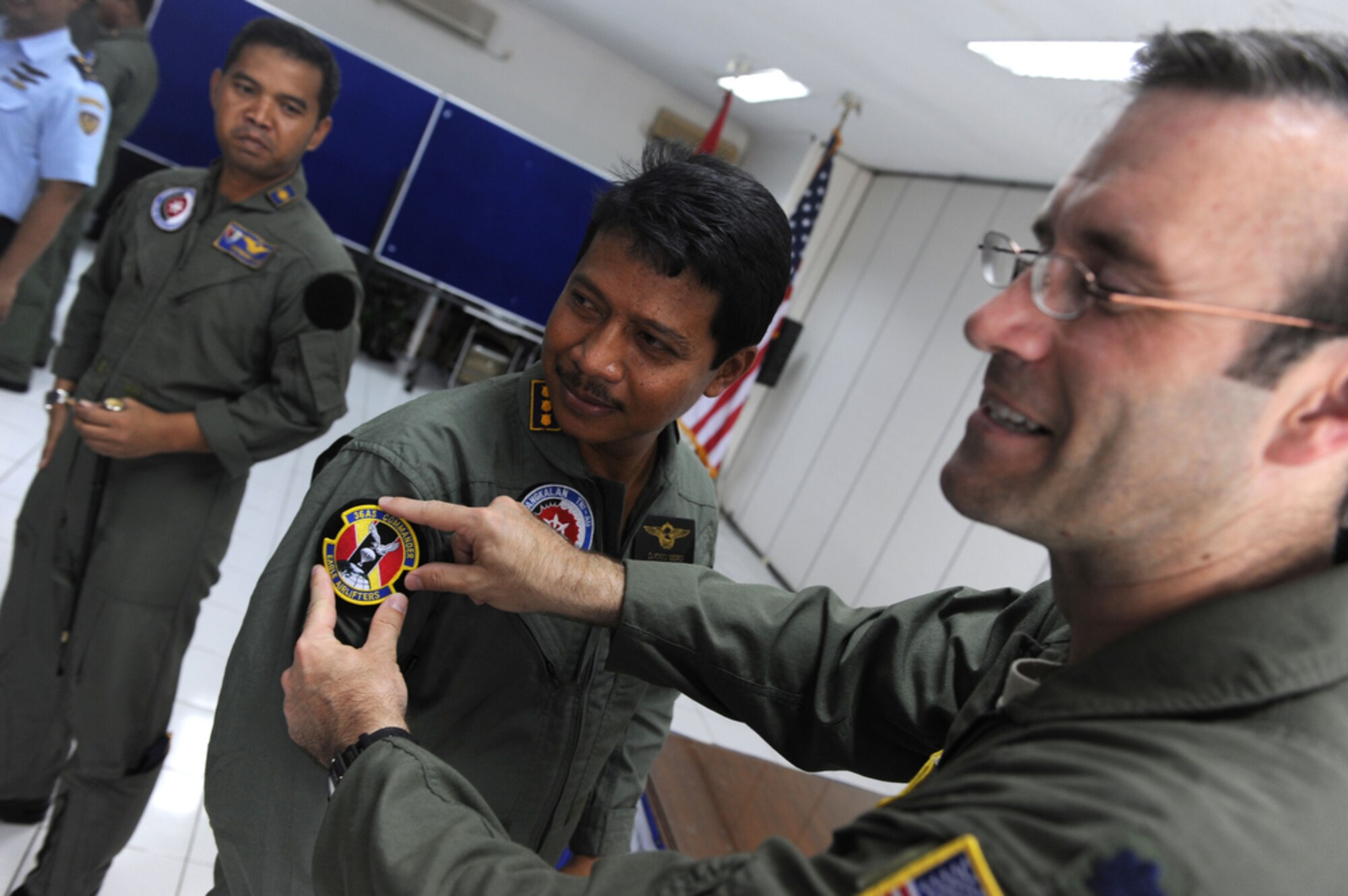 The Halim Air Base commander, Indonesian air force Colonel Djoko Senoputro, (center) exchanges squadron patches with the 36th Airlift Squadron commander, Lt. Col Dave Kincaid, at the closing ceremony of Cope West 10 on April 23 at Halim AB, Indonesia. Cope West is a Pacific Air Forces sponsored bilateral tactical airlift exercise involving the U.S. and Indonesian air forces. The exercise is designed to advance interoperability between the U.S. and Indonesian air forces, and promote cooperation and unity of purpose.  (U.S.  Air Force photo/Tech Sgt. Cohen A. Young)