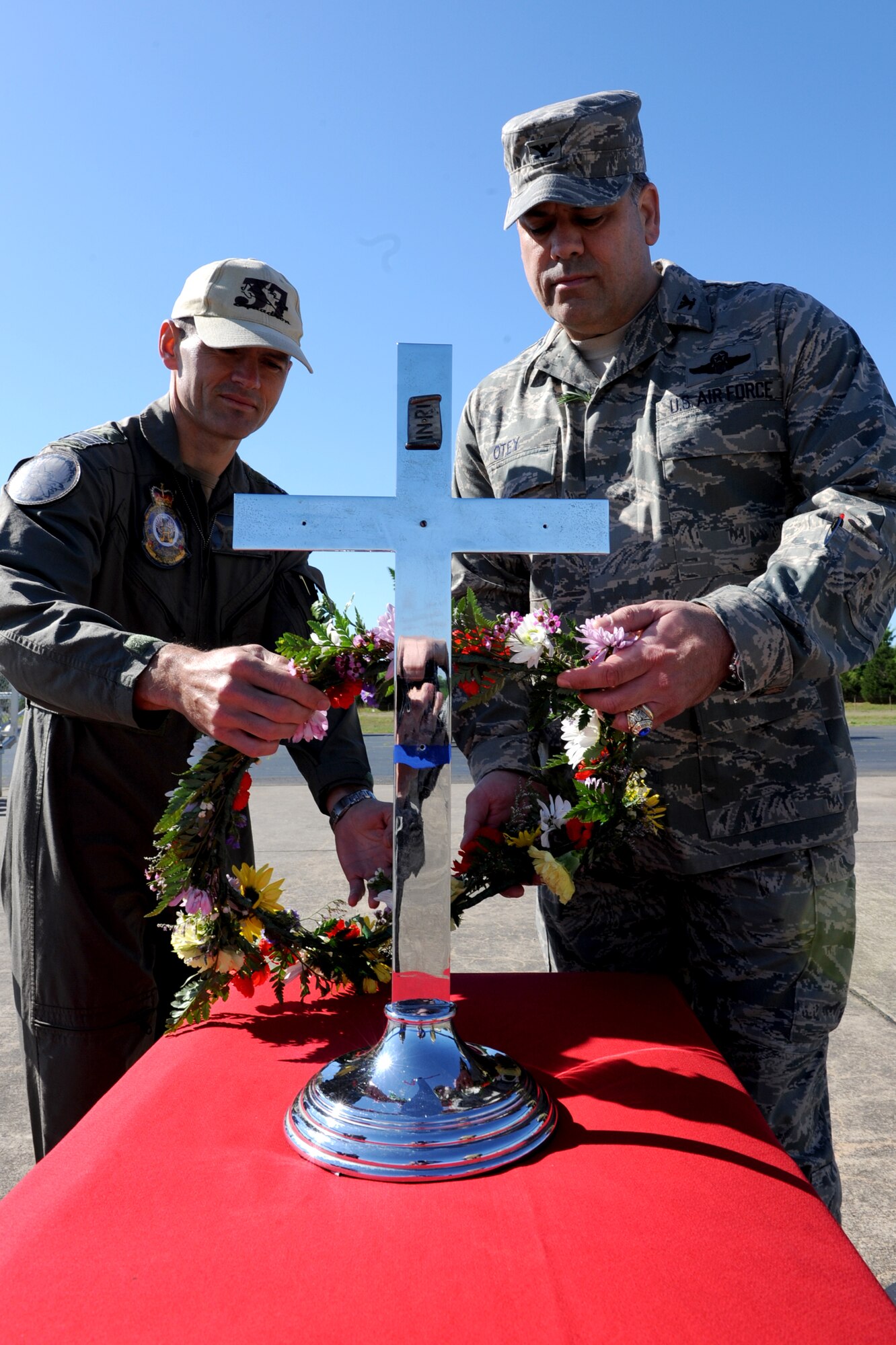 (Left) Wing Commander Matt Hegarty, Royal Australian Air Force 37 Squadron commanding officer, and Col. Greg Otey, 19th Airlift Wing commander, lay a wreath during the Australian and New Zealand Army Corps Day April 25 on the flightline at Little Rock Air Force Base. The laying of the wreath symbolizes the remembrance of the fallen Australian and New Zealand troops during the World War I.