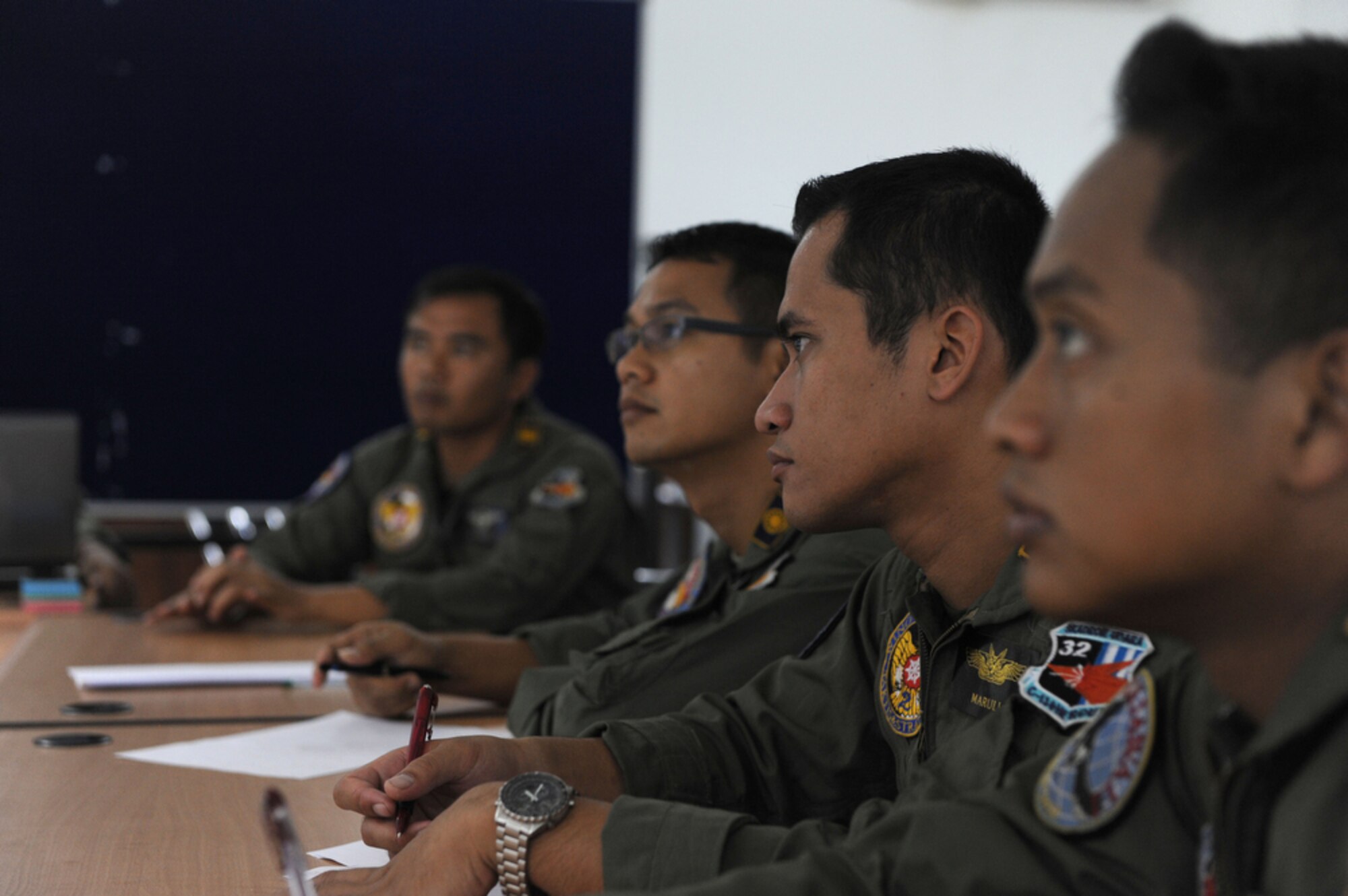 Indonesian air force pilots take in information while attending a training briefing on airdrop techniques while in support of Cope West 10 on April 23 at Halim Air Base, Indonesia. Cope West is a Pacific Air Forces sponsored bilateral tactical airlift exercise involving the U.S. and Indonesian air forces. The exercise is designed to advance interoperability between the U.S. and Indonesian air forces, and promote cooperation and unity of purpose.  (U.S.  Air Force photo/Tech Sgt. Cohen A. Young)