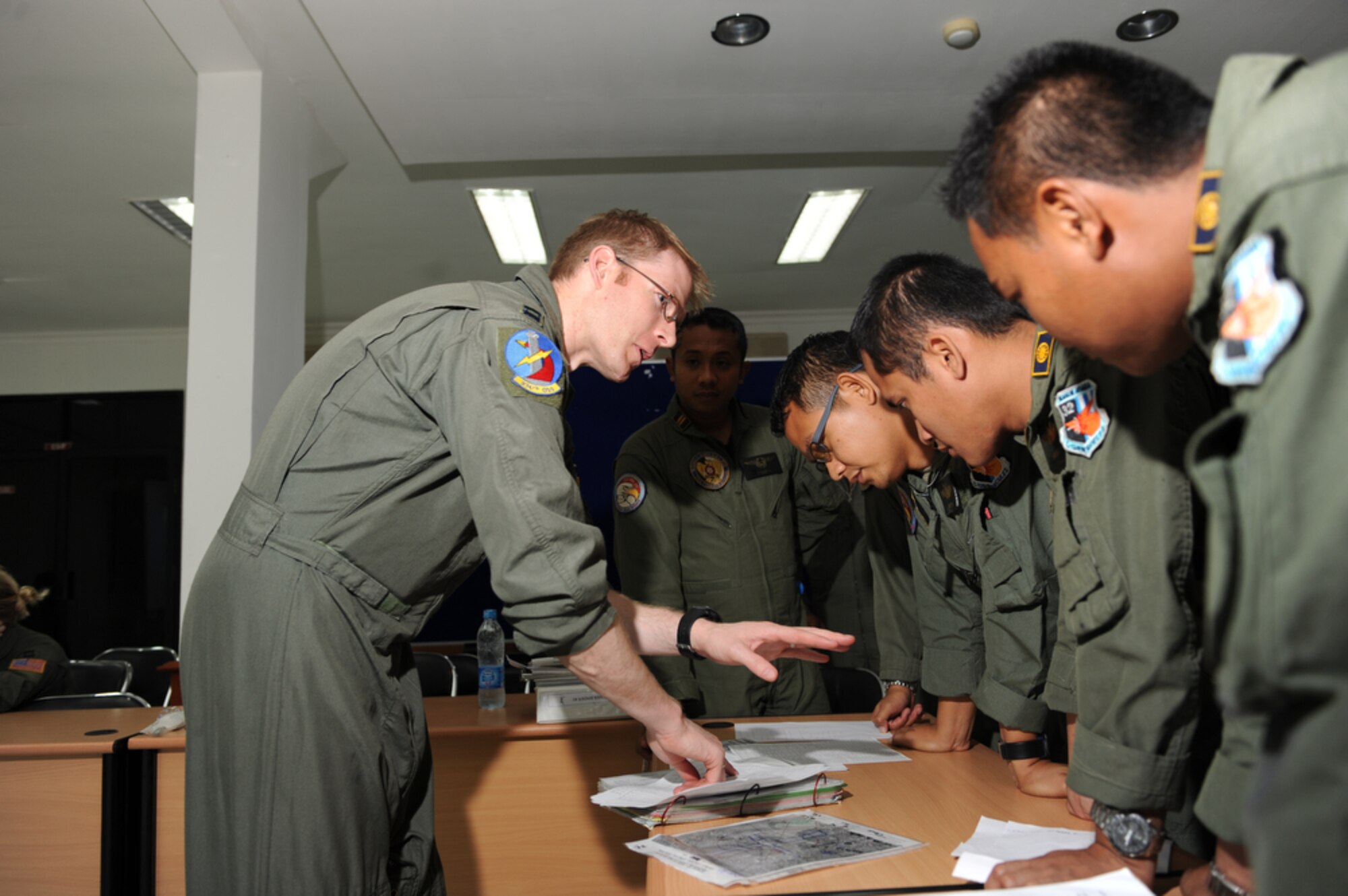Capt. Adam Shockley. a pilot from the 374th Airlift Wing at Yokota Air Base, Japan, reviews some flying techniques during a classroom session with Indonesian air force pilots while in support of Cope West 10 on April 23 at Halim Air Base, Indonesia. Cope West is a Pacific Air Forces sponsored bilateral tactical airlift exercise involving the U.S. and Indonesian air forces. The exercise is designed to advance interoperability between the U.S. and Indonesian Air Forces, and promote cooperation and unity of purpose. (U.S.  Air Force photo/Tech Sgt. Cohen A. Young)