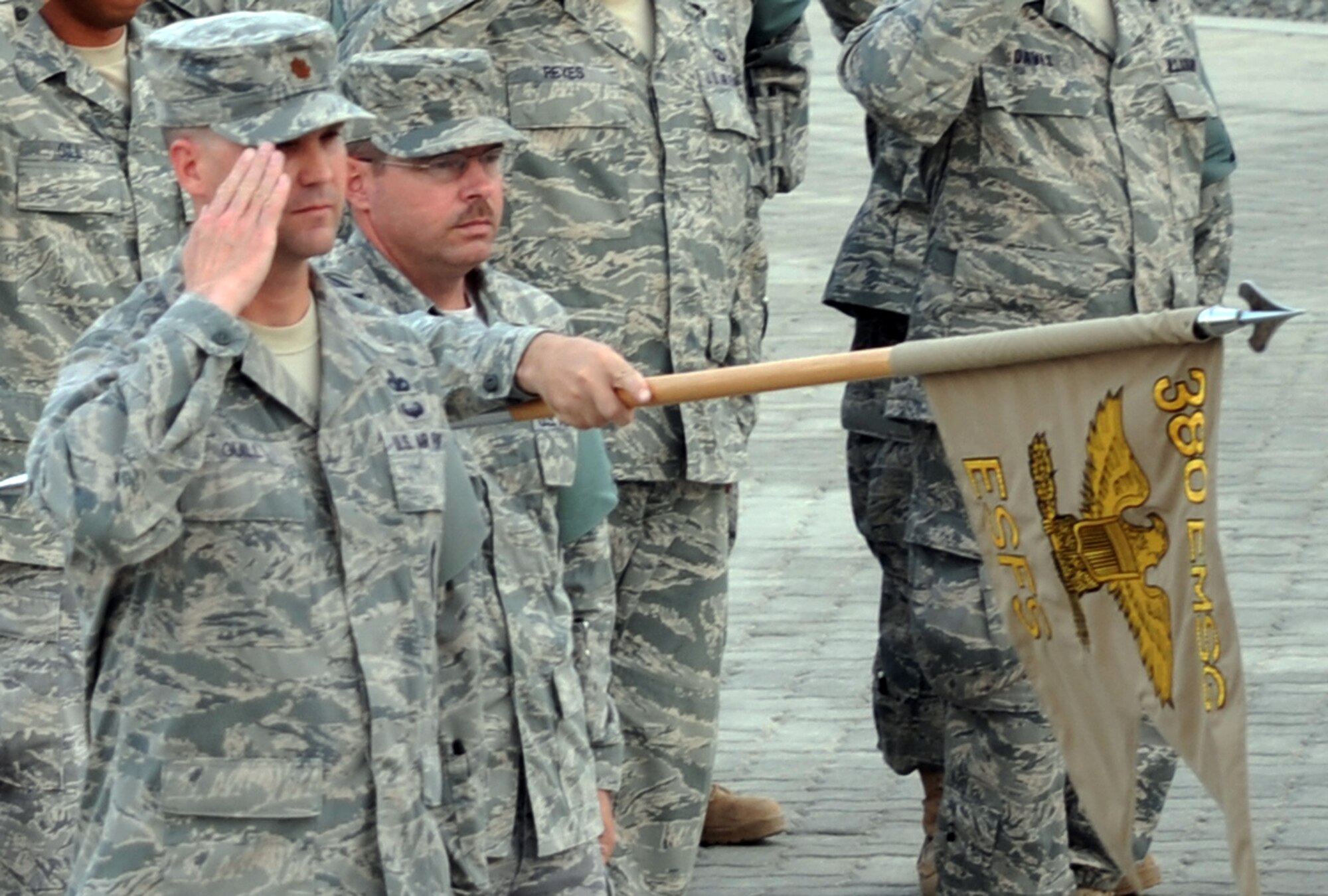 Maj. Aaron Guill, 380th Expeditionary Security Forces Squadron commander, and Chief Master Sgt. Timothy Standish, 380th ESFS chief enlisted manager, and other Airmen from the 380th Air Expeditionary Wing participate in a wing retreat ceremony at a non-disclosed base in Southwest Asia on April 23, 2010.  The 380th ESFS served as the lead formation for the ceremony. Each week, the 380th AEW pays tribute to the American flag and what it stands for by holding the wing-wide ceremony with various units leading the retreat each week.  (U.S. Air Force Photo/Master Sgt. Scott T. Sturkol/Released)