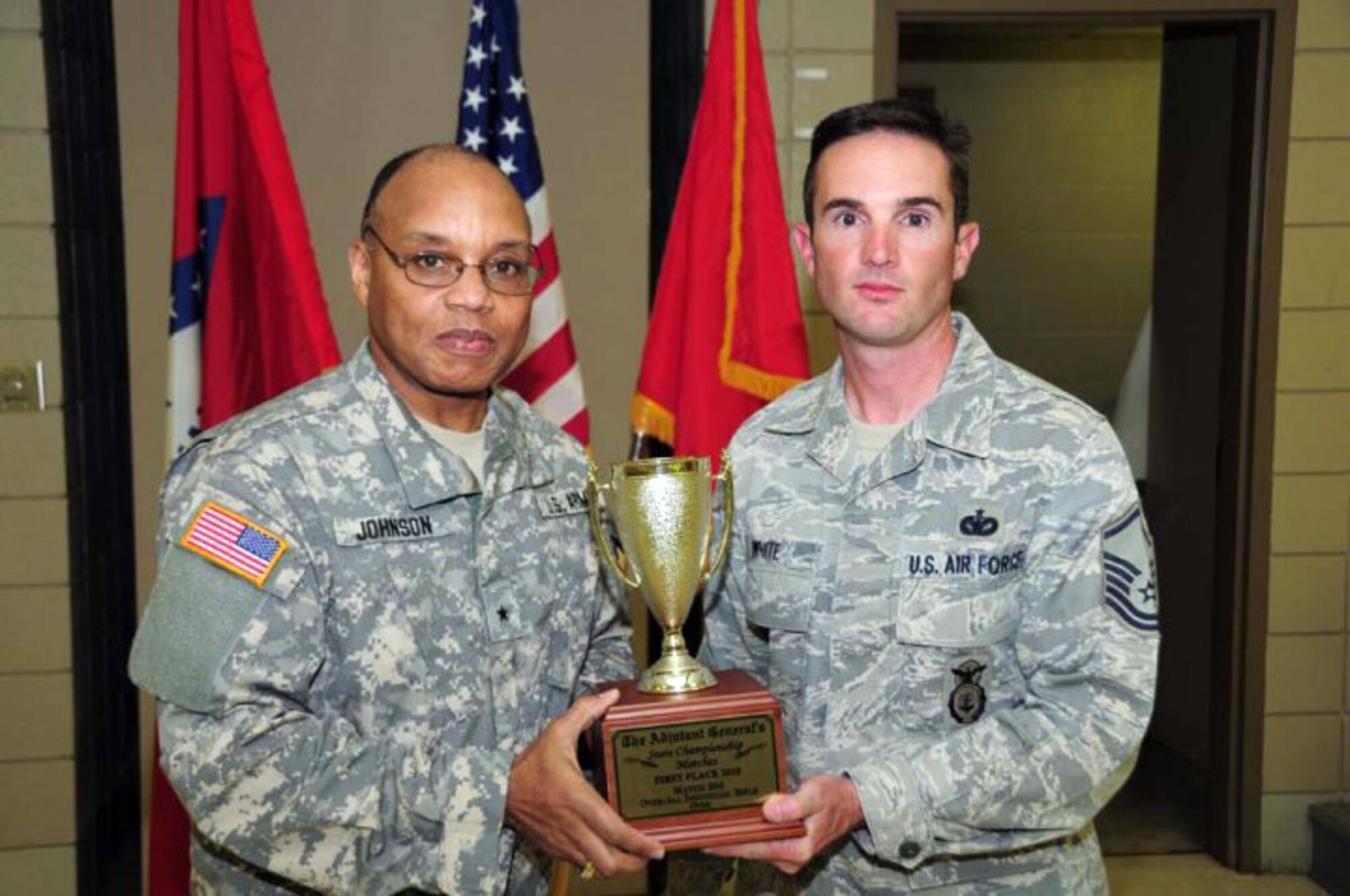 Brig. Gen. William Johnson, Deputy Adjutant General, Arkansas National Guard, left, presents the 1st-place trophy for Individual Rifle to the 188th Fighter Wing's Master Sgt. Ron White, Jr. at the 2010 Arkansas National Guard Adjutant General's (TAG) Marksmanship Sustainment Training Exercise held April 24-25 at Camp Joseph T. Robinson. (U.S. Army photo by Sgt. 1st Class Chris Durney/Arkansas National Guard Public Affairs)