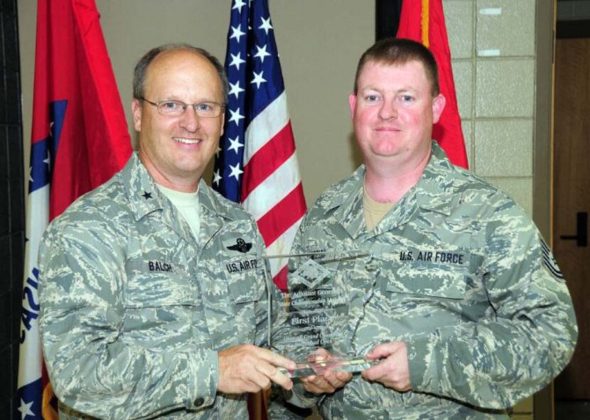 Brig. Gen. Travis D. Balch, Chief of Staff, Arkansas Air National Guard, left, presents the 188th Fighter Wing's Tech Sgt. Chad Niccum with the trophy for overall individual champion at the 2010 Arkansas National Guard Adjutant General's (TAG) Marksmanship Sustainment Training Exercise held April 24-25 at Camp Joseph T. Robinson. (U.S. Army photo by Sgt. 1st Class Chris Durney/Arkansas National Guard Public Affairs)