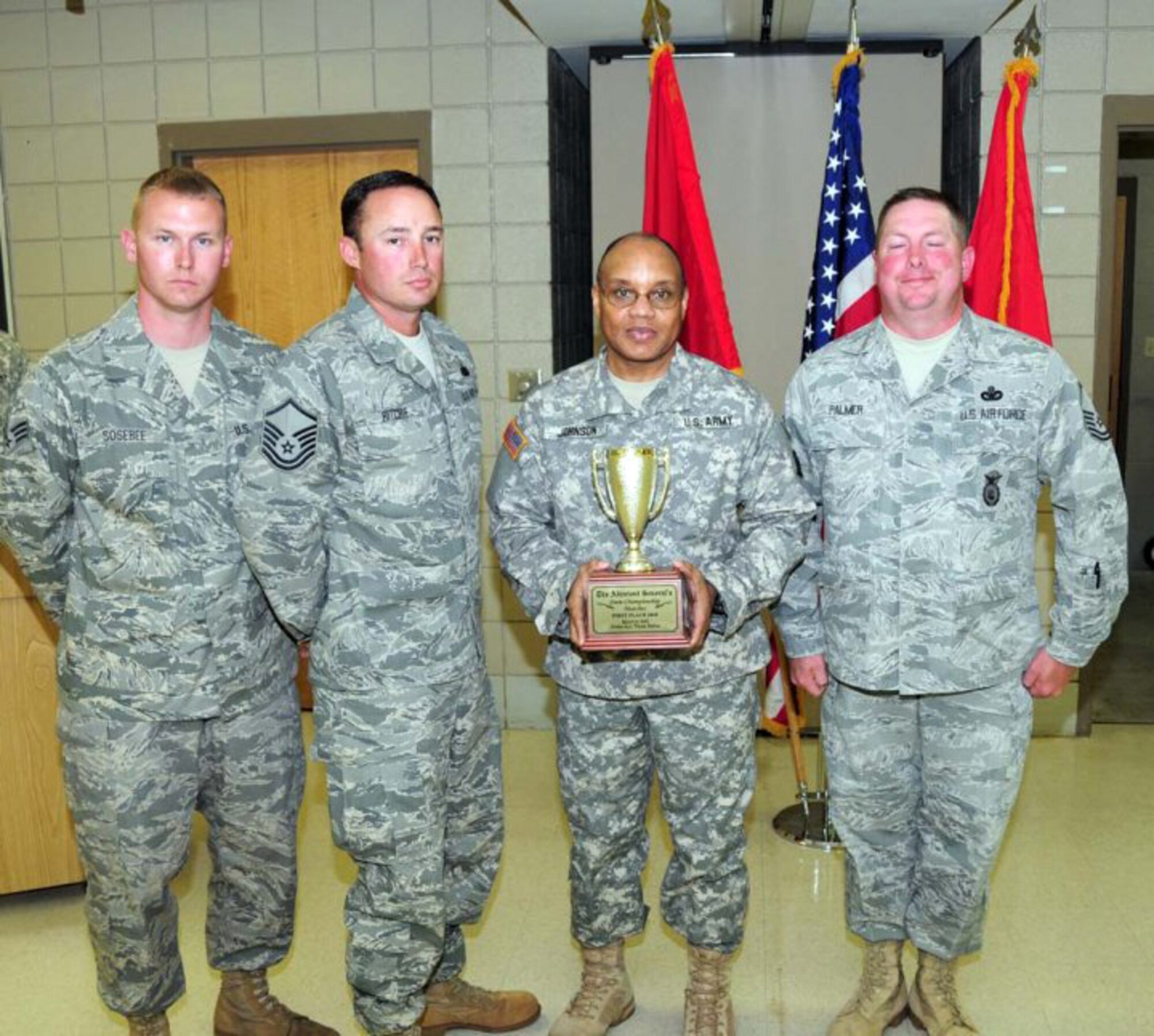 Brig. Gen. William Johnson, Deputy Adjutant General, Arkansas National Guard presents the 1st-place trophy for Team Rifle to the 188th Fighter Wing's Team White at the 2010 Arkansas National Guard Adjutant General's (TAG) Marksmanship Sustainment Training Exercise held April 24-25 at Camp Joseph T. Robinson. Team White, from left: Senior Airman Nathan Sosebee, Master Sgt. Michael Ritchie and Master Sgt. Gregory Palmer. Chief Master Sgt. Gary Taylor is not pictured. (U.S. Army photo by Sgt. 1st Class Chris Durney/Arkansas National Guard Public Affairs)