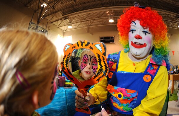 OFFUTT AIR FORCE BASE, Neb. -- Four-year-old Cayleigh Moser, daughter of Master Sgt. Bruce Moser, with the Air Force Weather Agency, gets her first look at the butterfly that's been painted on her face during the 2010 Family Fun Fair at the Youth Center here April 24. Hundreds of active-duty members and their families attended the event where they took part in numerous activities including face painting, coloring, horseback riding and much more. U.S. Air Force Photo by Josh Plueger.

