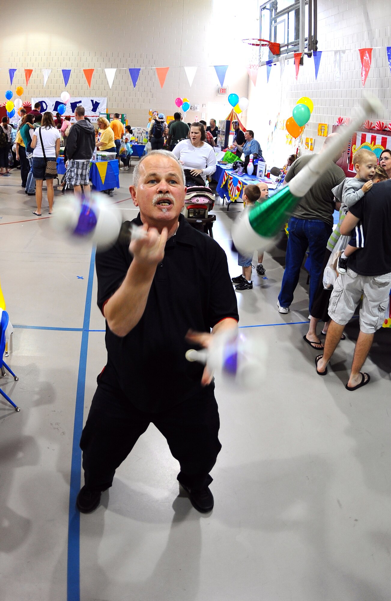 OFFUTT AIR FORCE BASE, Neb. -- Jek Kelly, a professional juggler, performs his juggling act at the Youth Center here April 24 during the 2010 Family Fun Fair. Hundreds of active-duty members and their families attended the event where they took part in numerous activities including face painting, coloring, horseback riding and much more. U.S. Air Force Photo by Josh Plueger.

