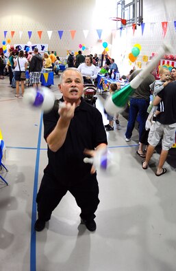 OFFUTT AIR FORCE BASE, Neb. -- Jek Kelly, a professional juggler, performs his juggling act at the Youth Center here April 24 during the 2010 Family Fun Fair. Hundreds of active-duty members and their families attended the event where they took part in numerous activities including face painting, coloring, horseback riding and much more. U.S. Air Force Photo by Josh Plueger.
